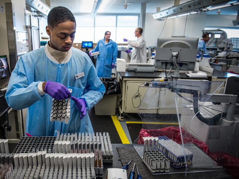 Staff Sgt. Gerald Gatlin prepares serology samples in the immunodiagnostic section of the Epidemiology Laboratory Service, also known as the ‘Epi Lab,’ at the 711th Human Performance Wing’s United States Air Force School of Aerospace Medicine and Public Health at Wright Patterson AFB, Ohio, Jan. 30, 2018. The immunodiagnostic section recently installed an automated testing unit, blue track on left, which is computer controlled to prepare samples and transfer them to the appropriate analyzer for STD screening, status-immune testing or other analyses. The system automatically reports results to Department of Defense clinics around the world, usually within 48 hours of a sample being shipped to the lab. (U.S. Air Force photo by J.M. Eddins Jr.)