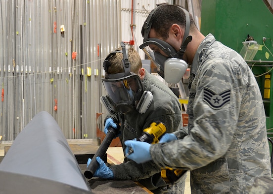 Airman 1st Class Clayton Langston (left) and Staff Sgt. Charles Swaim (right), aircraft structural maintenance technicians with the 445th Maintenance Squadron, prepare a newly received aircraft panel to be installed on a C-17 Globemaster III here Jan. 5, 2020. The new panel will protect the structure of the aircraft from debris and wear.(U.S. Air Force Photo/Staff Sgt. Ethan G. Spickler)