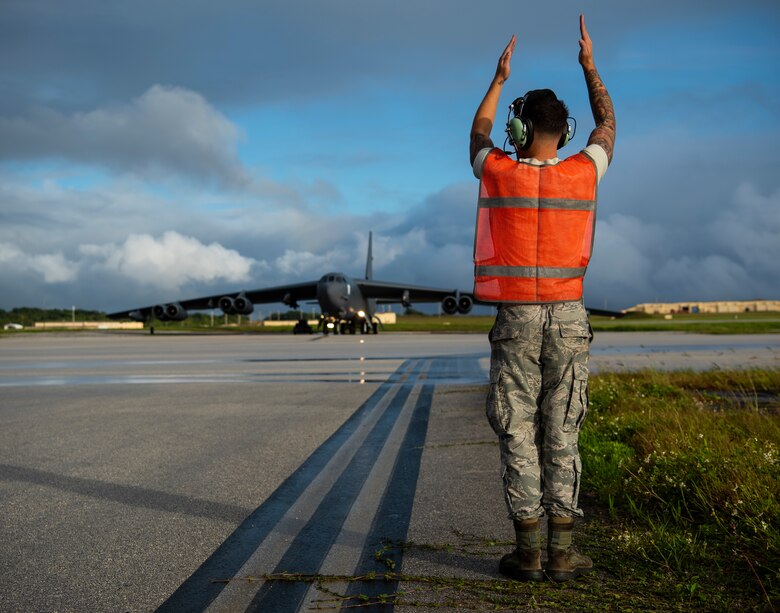 Senior Airman Patrick Cervoni Valentin, 69th Aircraft Maintenance Squadron dedicated crew chief, marshals a B-52H Stratofortress before a flight at Andersen Air Force Base, Guam, Feb. 3, 2020. Strategic bomber missions enhance the readiness and training necessary to respond to any potential crisis or challenge across the globe. (U.S. Air Force photo by Airman 1st Class Michael S. Murphy)