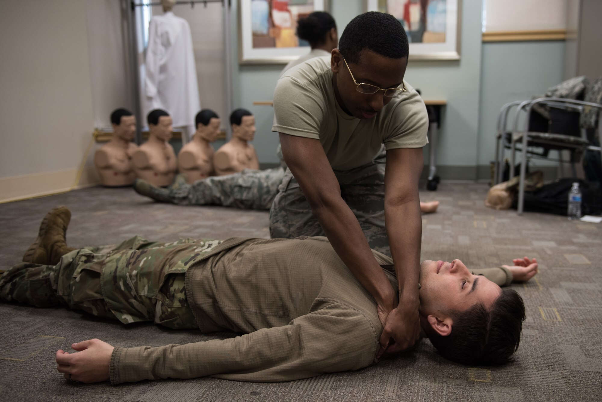 A U.S. Air Force medic practices finding hidden wounds at Joint Base Langley-Eustis, Virginia, January 22, 2020. The Tactical Combat Care Course teaches medics how to work with the limited supplies they would have in a deployed environment.  (U.S. Air Force photo by Airman 1st Class Sarah Dowe)