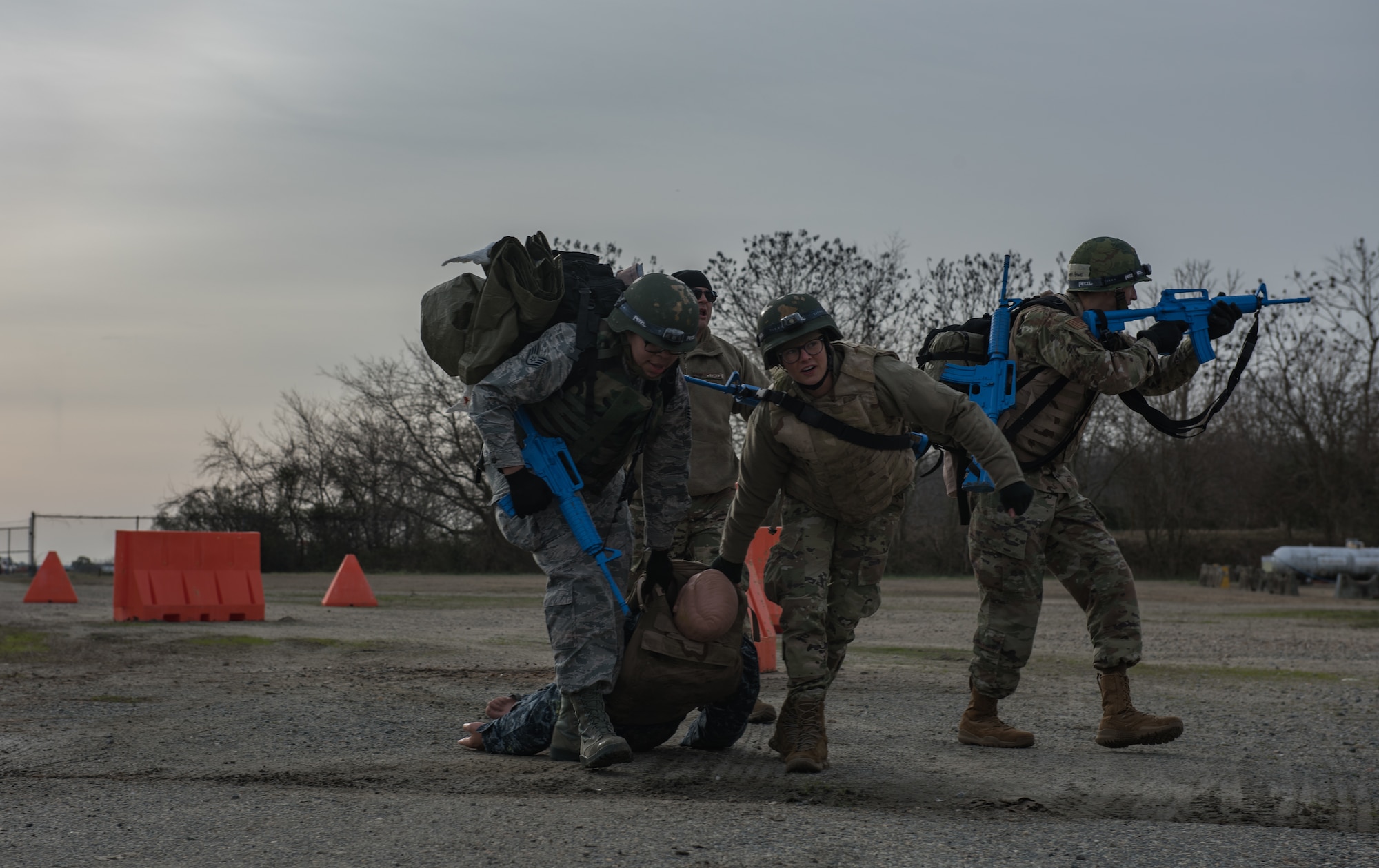 Medics move a simulated wounded patient to a safe environment for treatment at Joint Base Langley-Eustis, Virginia, January 24, 2020. The Tactical Combat Care Course helps medics become physically and mentally prepared to save lives in a hostile environment. (U.S. Air Force photo by Airman 1st Class Sarah Dowe)