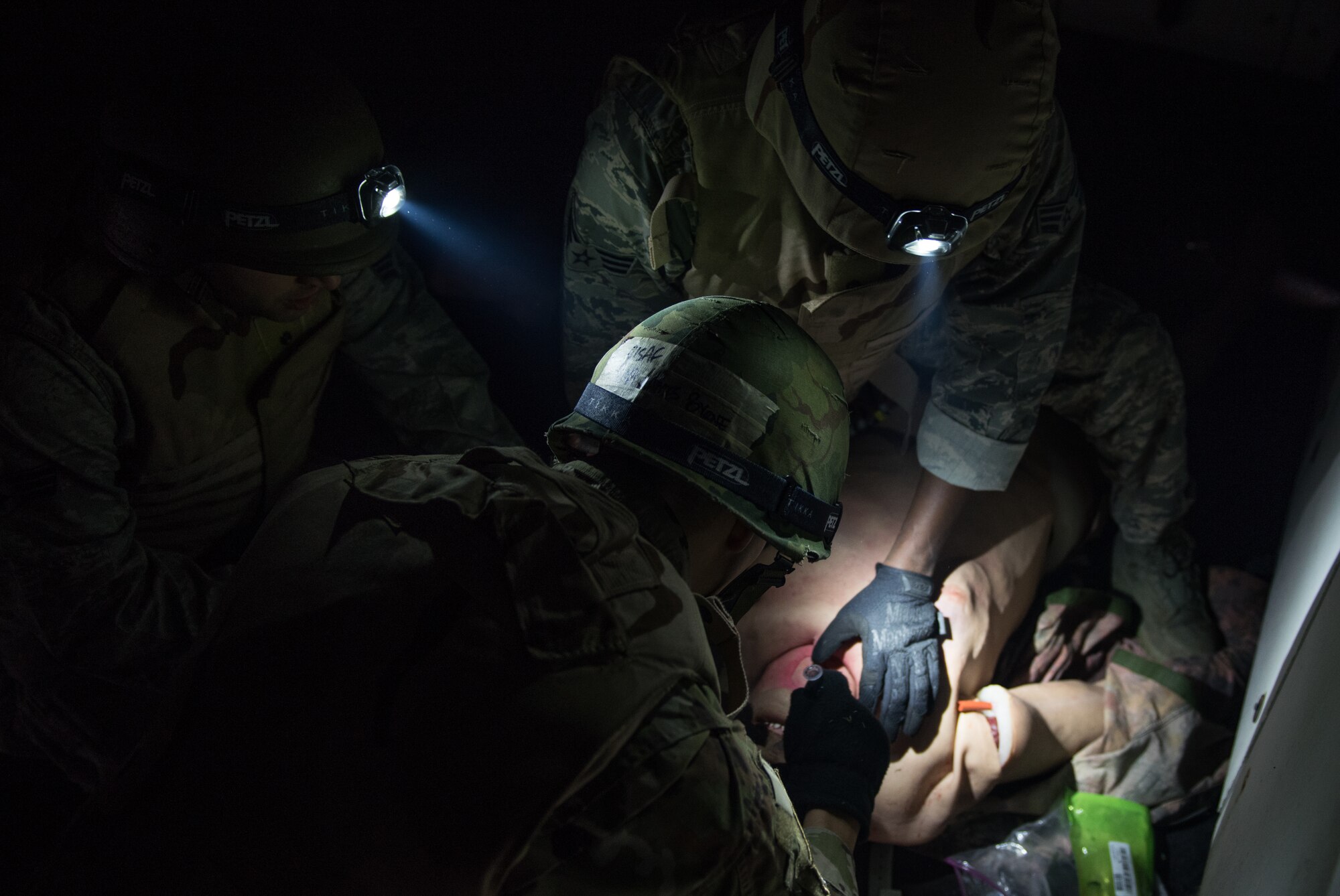 Medics treat a wounded “patient” (mannequin) at Joint Base Langley-Eustis, Virginia, January 24, 2020. The Tactical Combat Care Course teaches students how to react quickly to give life-saving care to wounded personnel. (U.S. Air Force photo by Airman 1st Class Sarah Dowe)