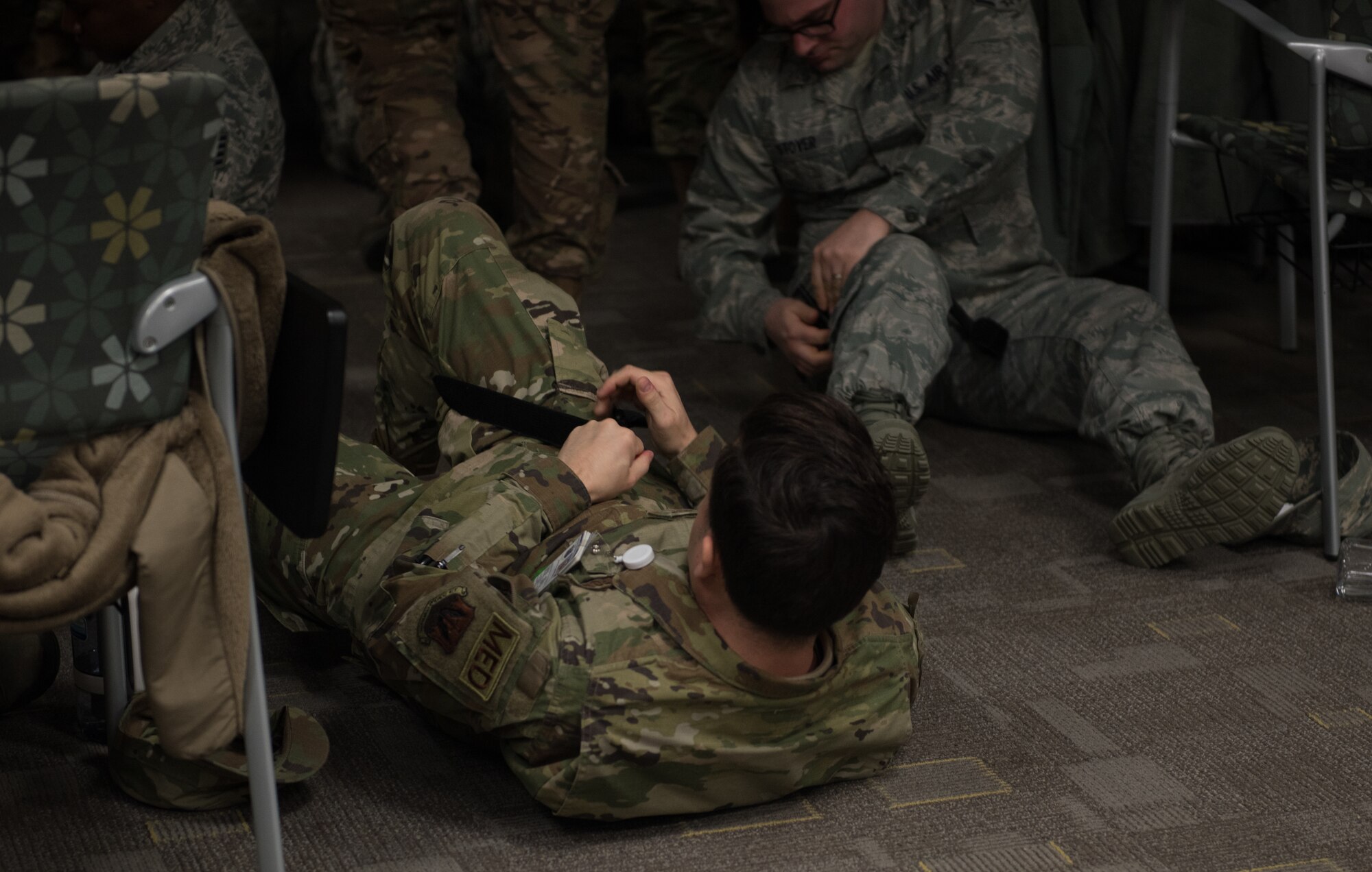 U.S. Air Force medics practice applying tourniquets to themselves at Joint Base Langley-Eustis, Virginia, January 22, 2020. The Tactical Combat Care Course teaches medics skills that they don’t practice on a regular basis.  (U.S. Air Force photo by Airman 1st Class Sarah Dowe)