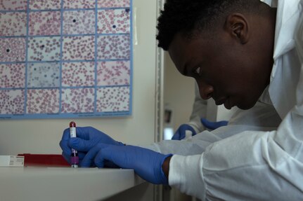 Airman 1st Class Chris Lawson, 20th Medical Support Squadron lab technician, places a drop of blood on a slide in the medical clinic at Shaw Air Force Base, S.C., Dec. 9, 2019. Lawson allowed the slide to dry before staining with different colors to make components such as white and red blood cells stand out from each other.