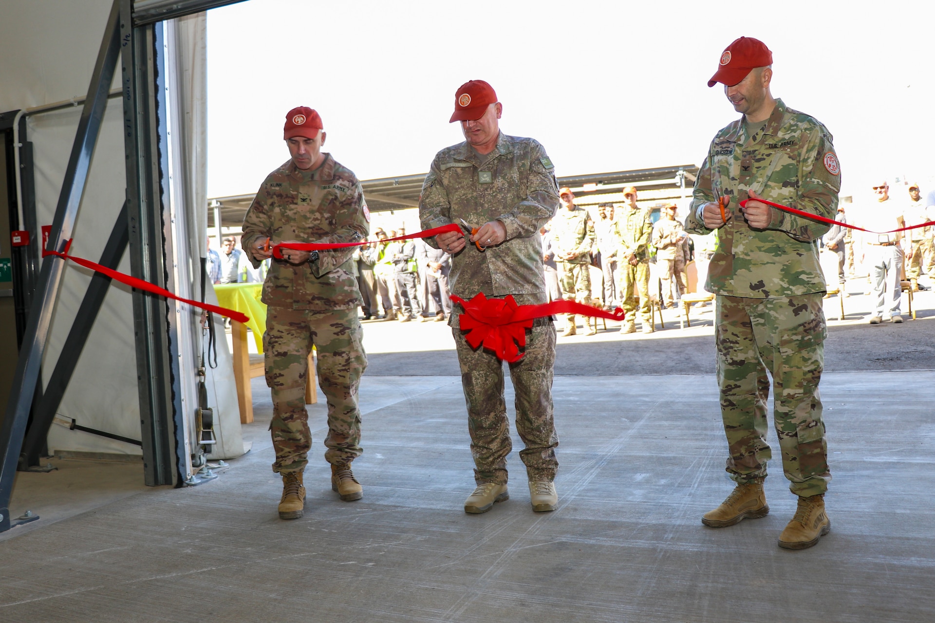 Col. Brandon Klink, left, deputy commander of Task Force Sinai, Maj. Gen. Evan Williams, center, force commander of the Multinational Force and Observers, and Col. Robert Duchaine, commander of Task Force Sinai and the chief of staff for the MFO, cut the ribbon entering the new Supply Support Activity facility on South Camp, Egypt, Jan. 16, 2020. The new facility is essential to the controlled receiving, distribution, issuing and storage of stocked parts supporting the Multinational Force and Observers mission.(U.S. Army photo by Staff Sgt. Eliverto V. Larios)