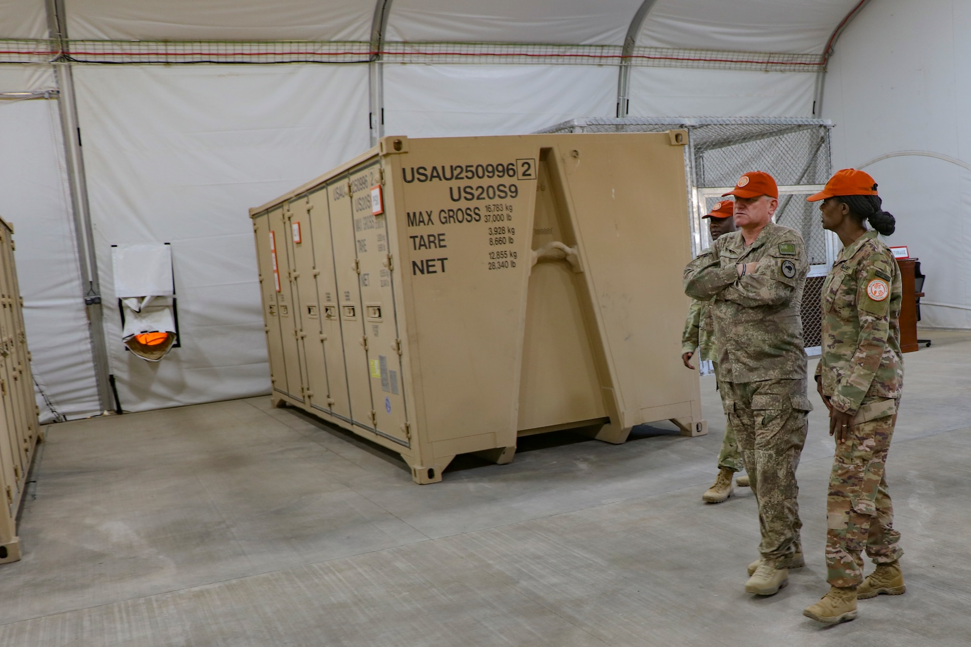 Chief Warrant Officer 3 Tammy Smith, right, the officer in charge of the Supply Support Activity for Task Force Sinai, provides Maj. Gen. Evan Williams, force commander of the Multinational Force and Observers, a tour of the new SSA facility on South Camp, Egypt, Jan. 16, 2020. The new facility is essential to the controlled receiving, distribution, issuing and storage of stocked parts supporting the Multinational Force and Observers mission. (U.S. Army photo by Staff Sgt. Eliverto V. Larios)