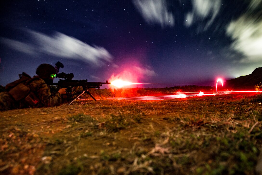 Machine gunner fires into the night.