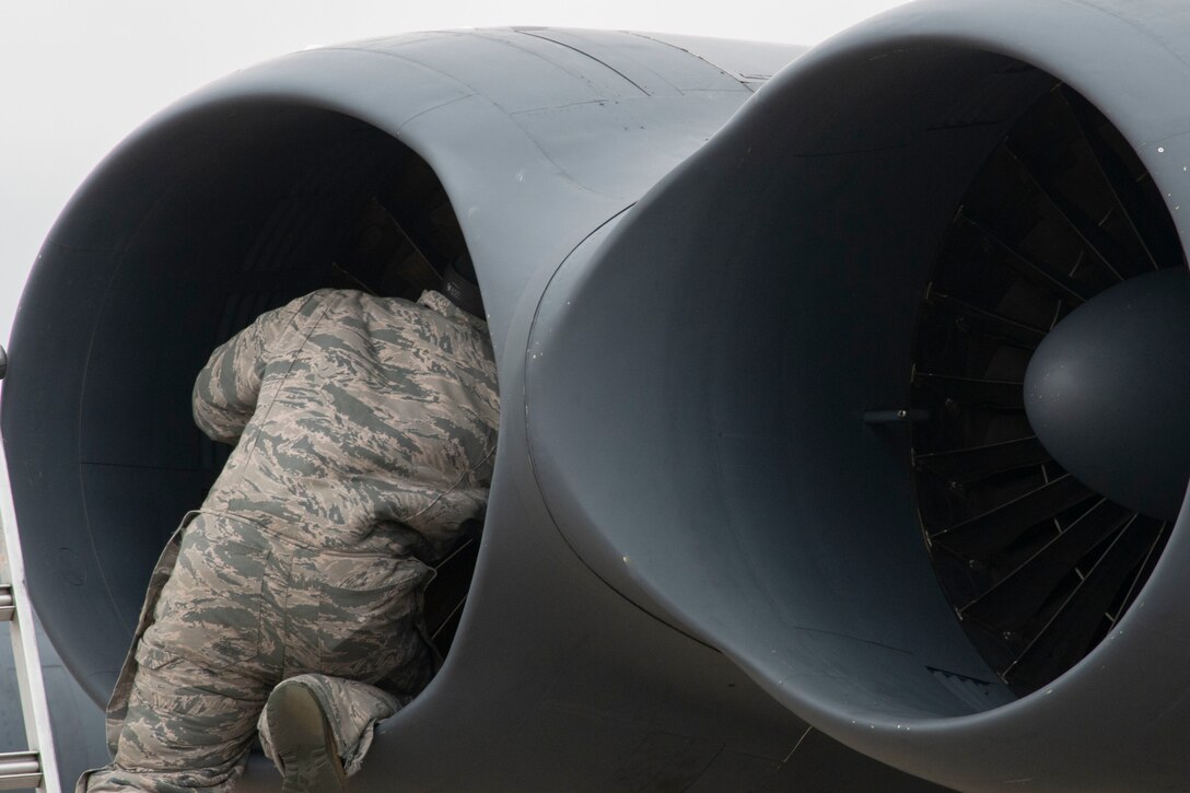 Photo of Airman checking out B-52 engine.