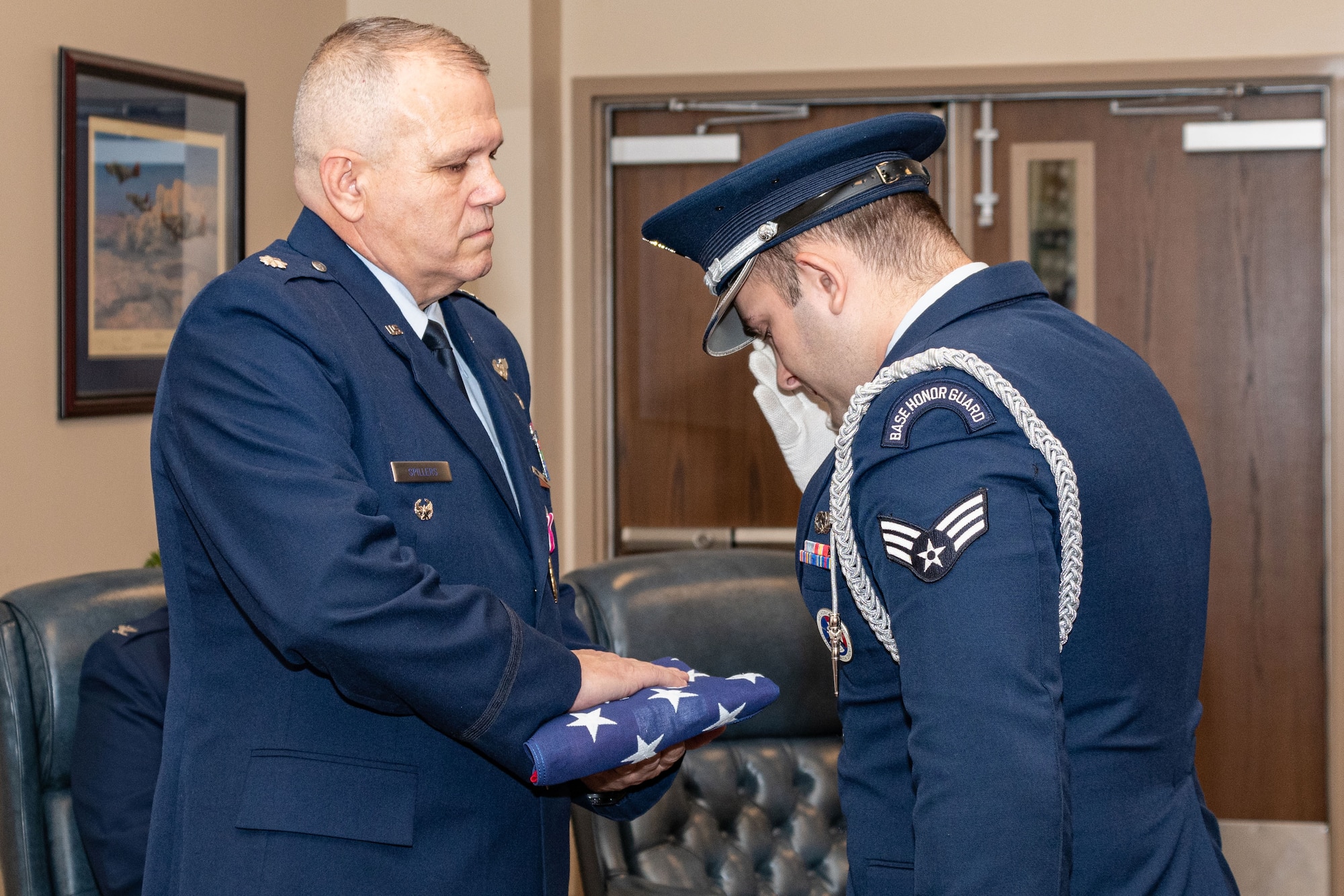 Photo of Col. Spillers holding flag.