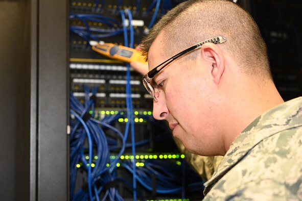 Photo of airman checking switches.