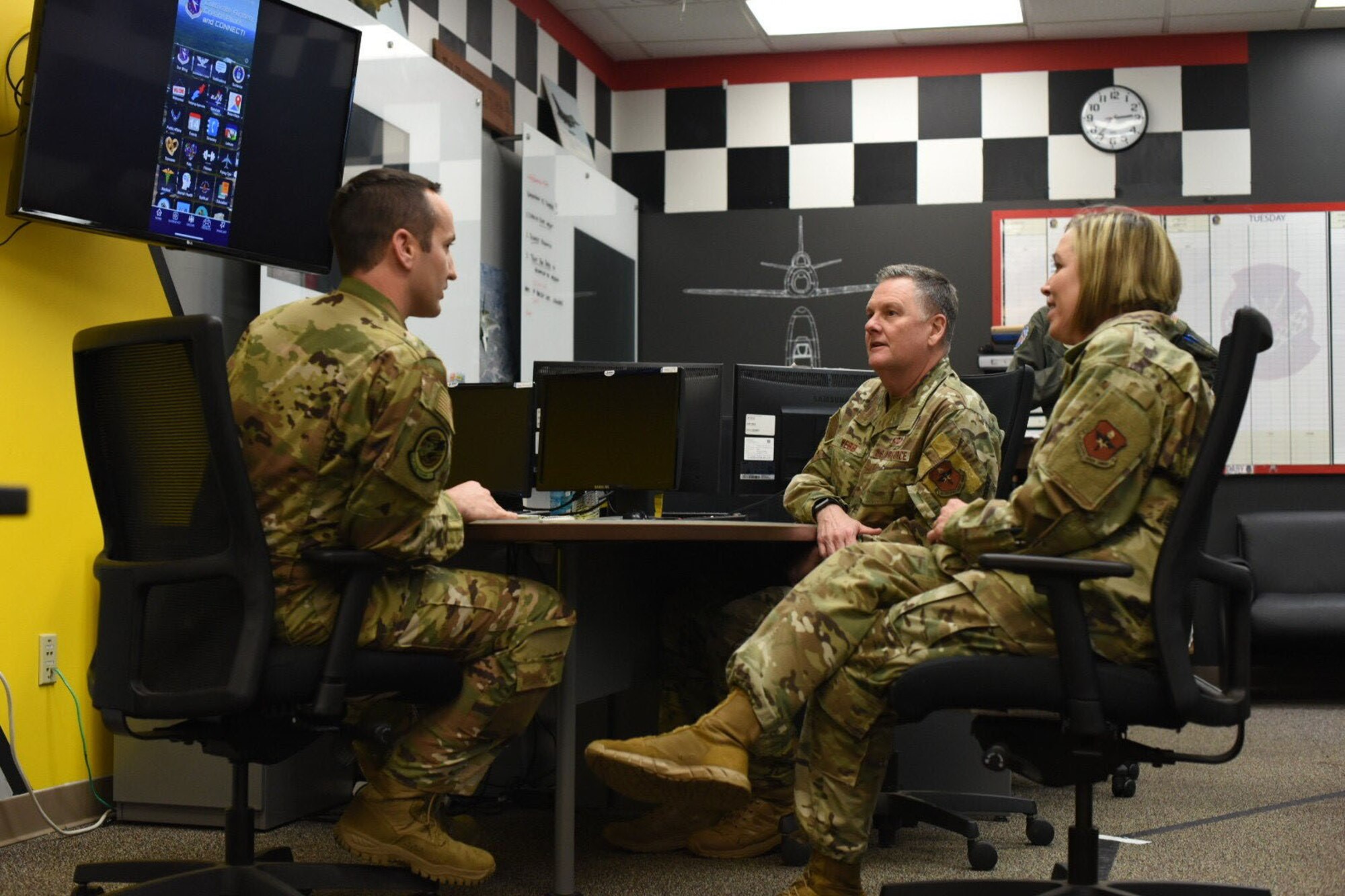 U.S. Air Force Lt. Gen. Brad Webb, commander of Air Education and Training Command, and Chief Master Sgt. Juliet Gudgel, command chief of AETC, are briefed by Maj. Tory Lodmell, 14th Flying Training Wing Commander’s Action Group director, about the Columbus Air Force Base mobile app Feb. 5, 2020, on Columbus AFB, Mississippi. The app was designed for members of team BLAZE to have pertinent information about the base including a directory, map, activities and pop up notifications. (U.S. Air Force photo by Senior Airman Keith Holcomb)