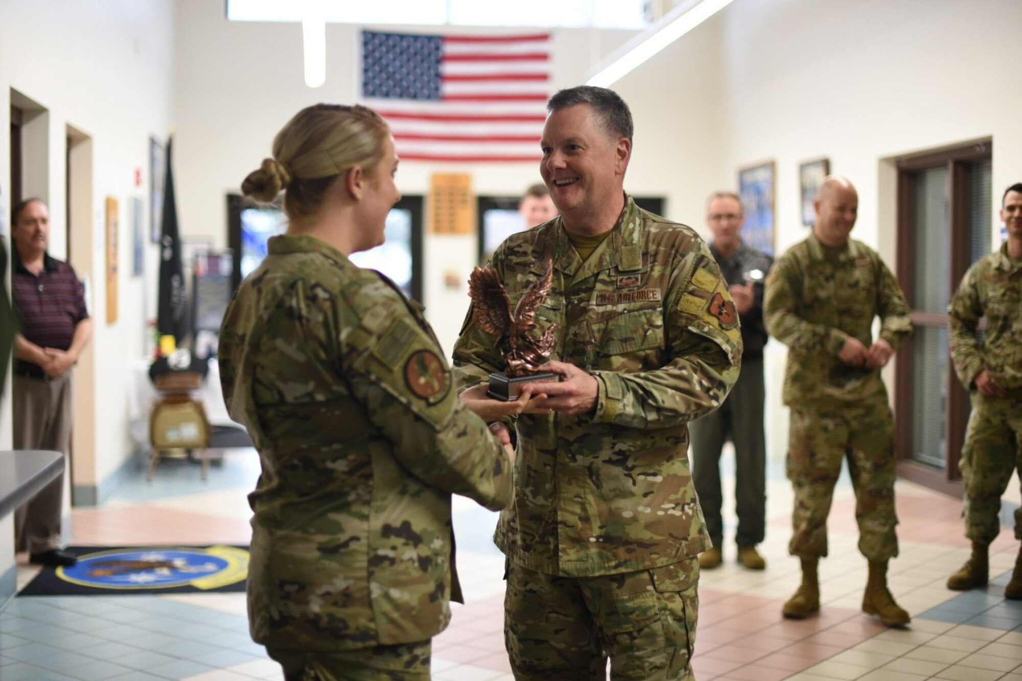 U.S. Air Force Lt. Gen. Brad Webb, commander of Air Education and Training Command, and Chief Master Sgt. Juliet Gudgel, command chief of AETC, present coins to outstanding performers of the 14th Flying Training Wing during their visit Feb. 5, 2020, on Columbus AFB, Mississippi. The app was designed for members of team BLAZE to have pertinent information about the base including a directory, map, activities and pop up notifications. (U.S. Air Force photo by Senior Airman Keith Holcomb)
