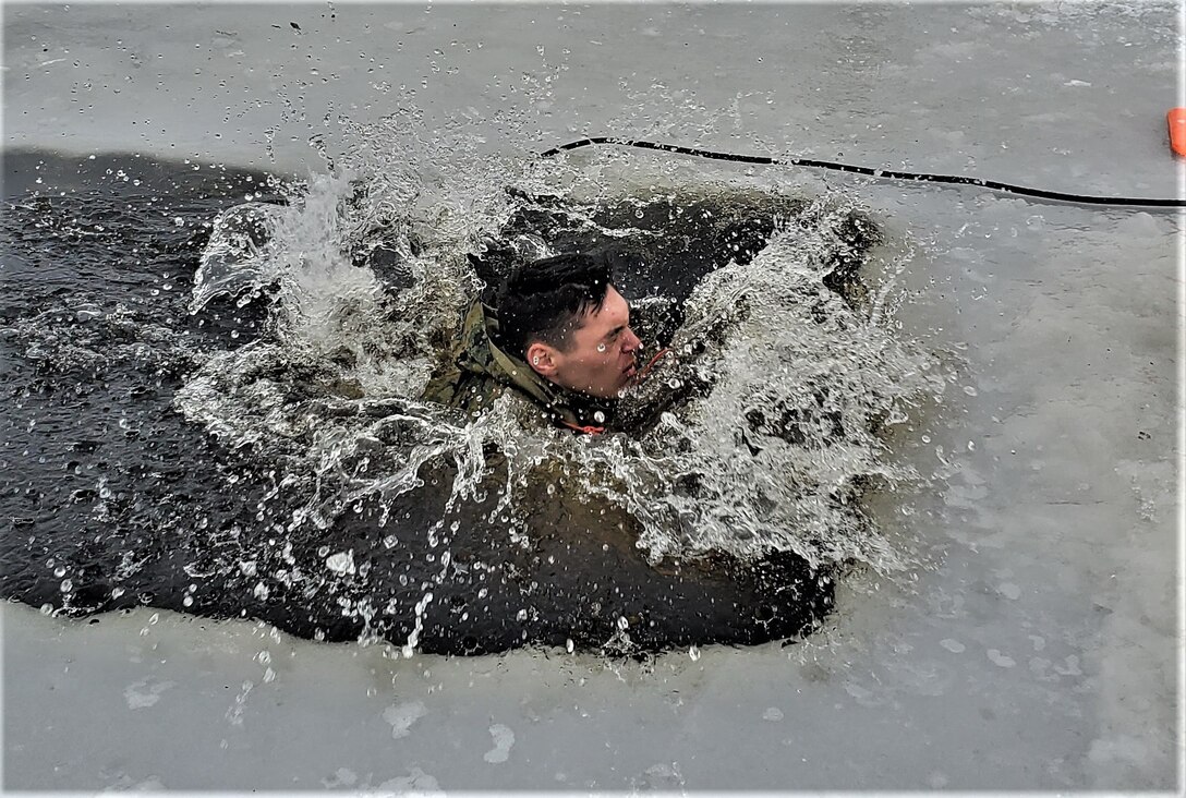 A student makes a splash while plunging into cold water.
