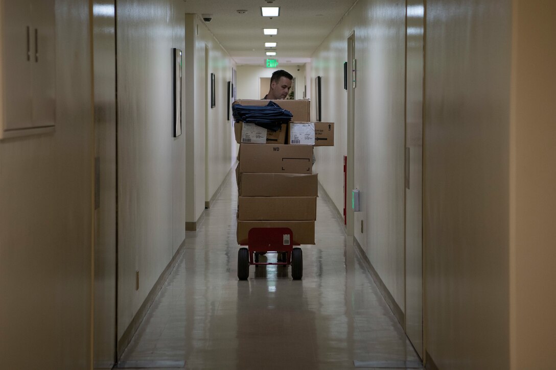 U.S. Air Force Staff Sgt. Jonathan Weishuhn, 18th Aircraft Maintenance Squadron resource advisor, transports newly-acquired maintenance shorts to his squadron Jan. 14, 2020, at Kadena Air Base, Japan. The shorts are intended to alleviate some of the heat stress maintenance Airmen experience while operating under the hot Okinawa sun. (U.S. Air Force photo by Senior Airman Rhett Isbell)