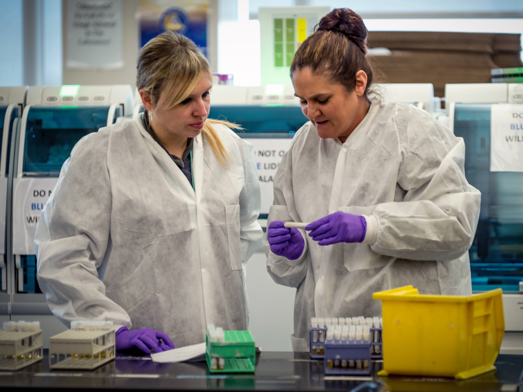 Lindsey White and Tiffany Miracle prepare serology samples to load into an automated analysis system in the immunodiagnostic section of the Epidemiology Laboratory Service, also known as the ‘Epi Lab,’ at the 711th Human Performance Wing’s United States Air Force School of Aerospace Medicine and Public Health at Wright Patterson AFB, Ohio, Jan. 30, 2018. (U.S. Air Force photo by J.M. Eddins Jr.)