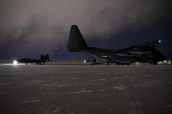 Forward Area Refueling Point aircrew members with the 27th Special Operations Wing refuel an F-22 Raptor with the 3rd Wing from an MC-130J Commando II during Emerald Warrior at Joint Base Elmendorf-Richardson, Alaska, Jan. 30, 2020. This was considered the first-ever simulated Forward Area Refueling Point for F-22 Raptors in an extreme cold weather environment. Emerald Warrior 20-1 provides annual, realistic pre-deployment training encompassing multiple joint operating areas to prepare special operations forces, conventional force enablers, partner nations, and interagency elements to integrate with and execute full spectrum special operations in an arctic climate, sharpening U.S. forces’ abilities to operate around the globe. (U.S. Air Force photo by Staff Sgt. Ridge Shan)