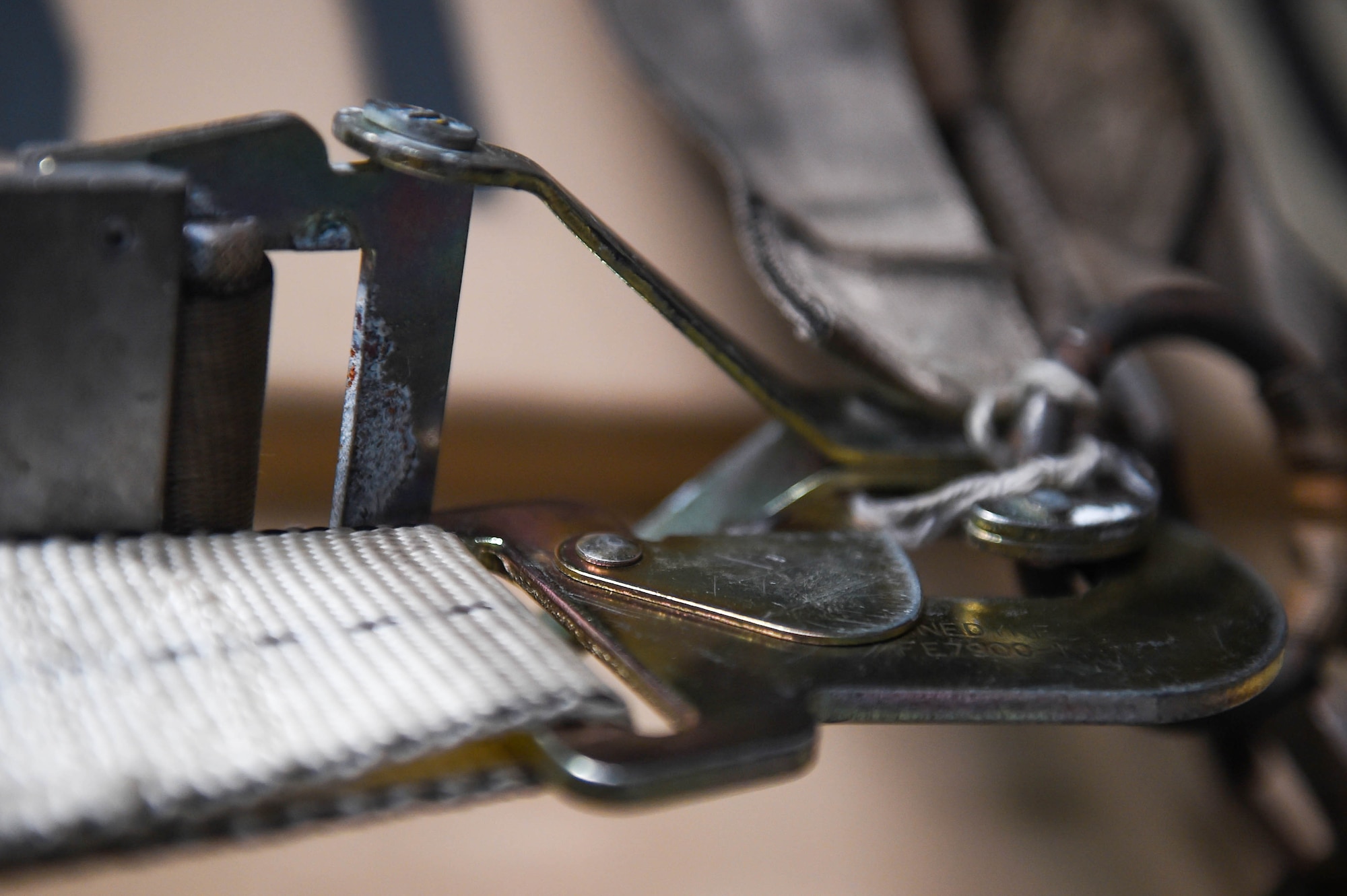 An additional strap is attached to cargo netting on a piece of cargo aboard a C-17 Globemaster III before taking off from Spangdahlem Air Base, Germany, Dec. 18, 2019. The metal piece at the end of an existing strap had started to deteriorate, so as an added security measure the loadmasters attached one of their straps. (U.S. Air Force photo by Airman 1st Class Mikayla Heineck)