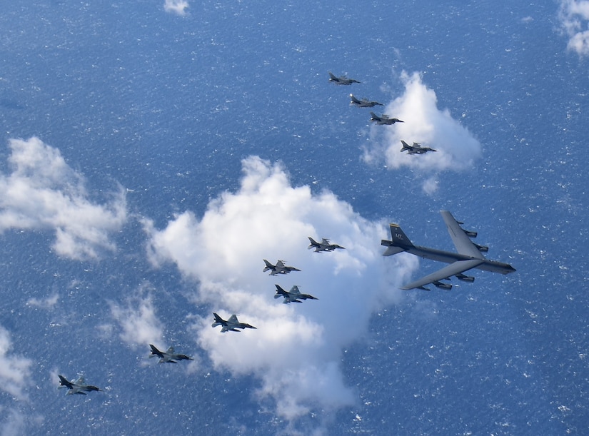 U.S. and Japanese fighters escort a U.S. strategic bomber.