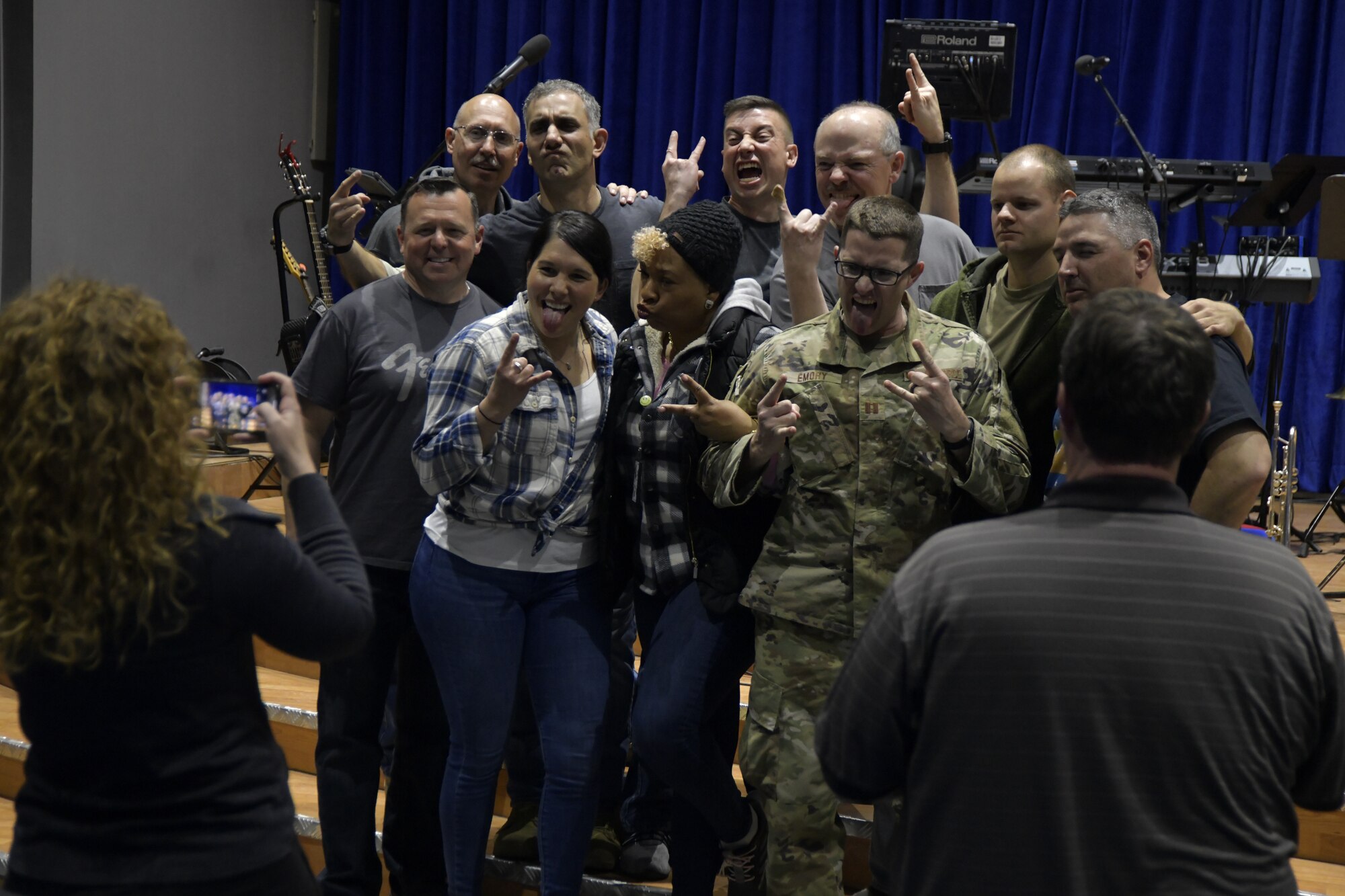 Air Forces Central Command Band members take a photo with an audience member after performing at The Rock theater at Ali Al Salem Air Base, Kuwait January 3, 2020. These dynamic musicians perform and tour in small ensembles throughout the AOR to positively promote troop morale, diplomacy and outreach to host nation communities. This team is coming from the Pennsylvania Air National Guard. (U.S. Air Force photo by Tech. Sgt. Alexandre Montes)