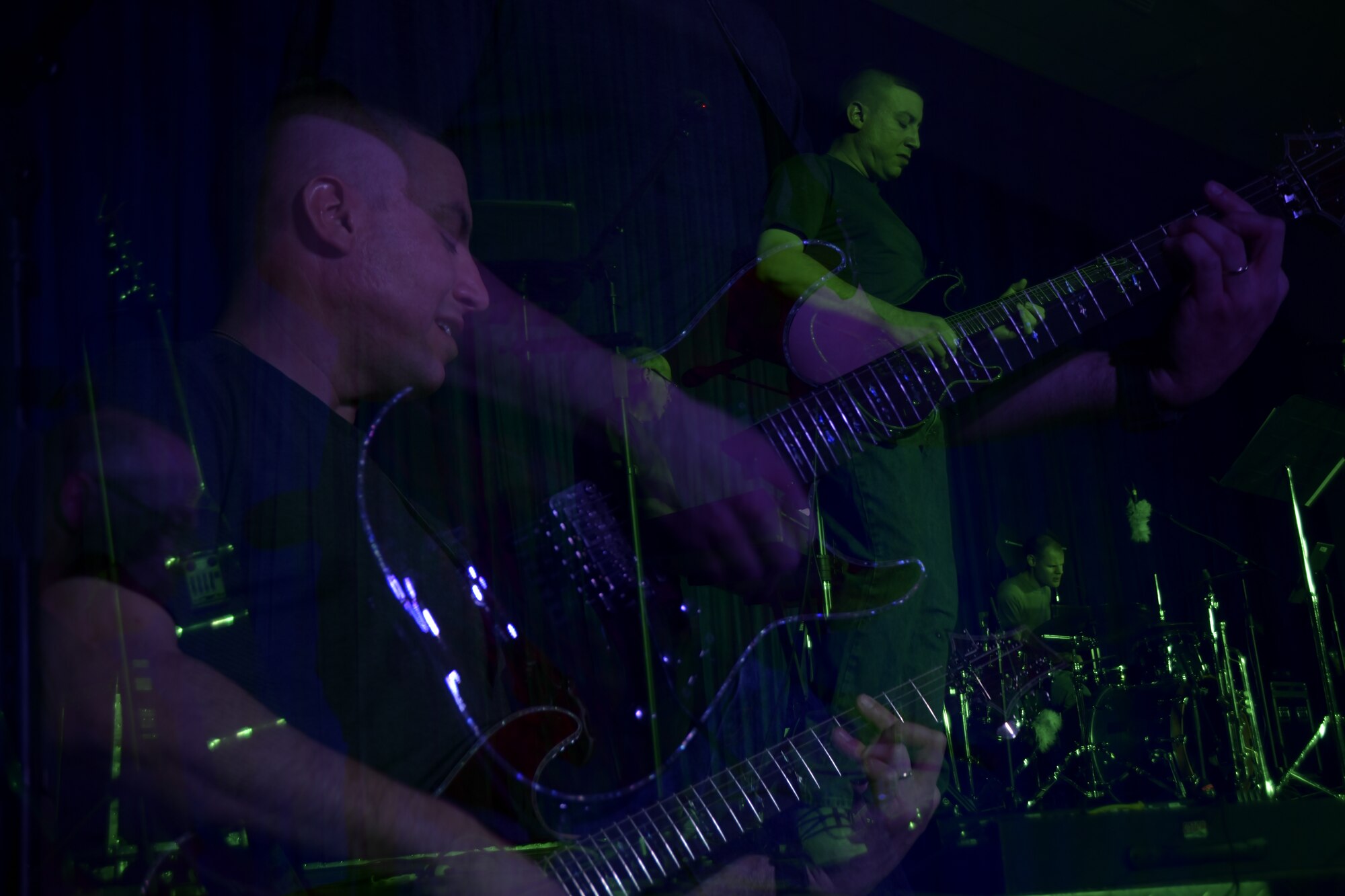 Tech. Sgt. Andre Minns, Air Forces Central Command Band member, plays a guitar solo during his performance for deployed members in The Rock theater at Ali Al Salem, Kuwait January 3, 2020. The AFCENT Band is comprised of Airmen that have been selected by musical proficiency and then travel communicating to deployed members and local communities through music. (U.S. Air Force photo by Tech. Sgt. Alexandre Montes)