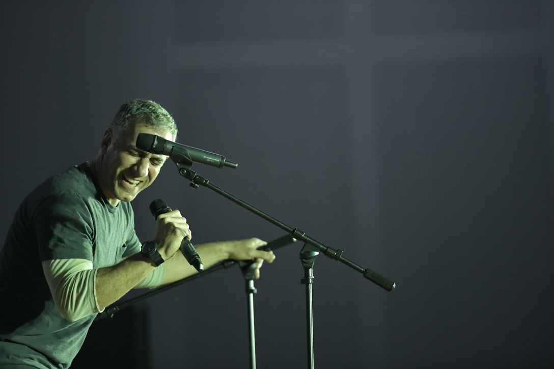 Airman 1st Class Jonathan Delise, Air Forces Central Command Band member, sings a rock song cover solo at The Rock theater at Ali Al Salem, Kuwait January 3, 2020. These dynamic musicians perform and tour in small ensembles throughout the AOR to positively promote troop morale, diplomacy and outreach to host nation communities. This team is coming from the Pennsylvania Air National Guard. (U.S. Air Force photo by Tech. Sgt. Alexandre Montes)