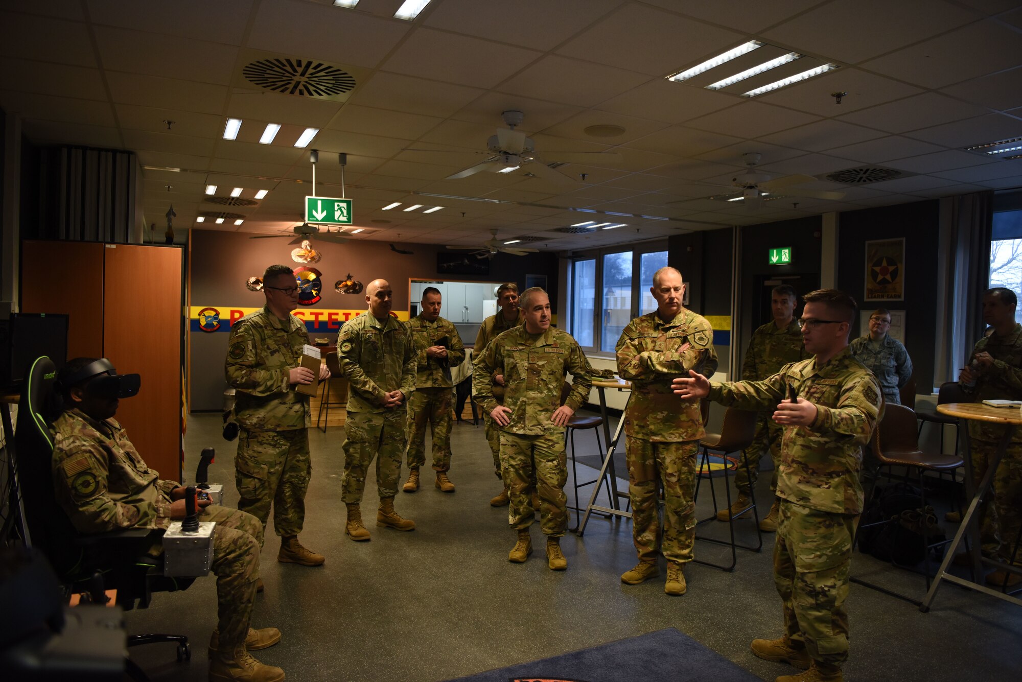 U.S. Air Force Maj. Gen. John Gordy, U.S. Air Force Expeditionary Center commander and Chief Master Sgt. Kristopher Berg, Air Force Expeditionary Center command chief, watch a virtual reality demonstration at the 721st Aircraft Maintenance Squadron during a 521st Air Mobility Operations Wing visit at Ramstein Air Base, Germany, Jan. 29, 2020. The 721st AMXS highlighted their innovative virtual reality training program that allows their members to get familiar with aircraft maintenance before stepping on a flight line, ultimately saving time and funds. The U.S. Air Force Expeditionary Center is the Air Force's center of excellence for rapid global mobility and expeditionary agile combat support training and education.