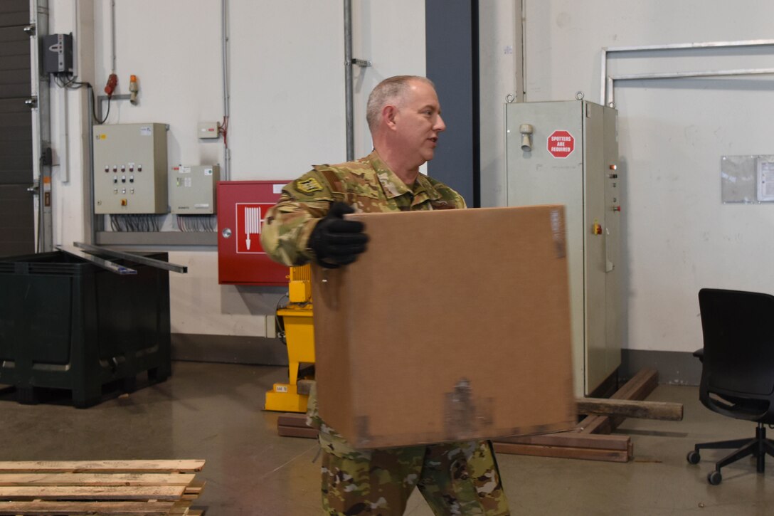 U.S. Air Force Maj. Gen. John Gordy, U.S. Air Force Expeditionary Center commander, carries cargo at works with Airmen at the passenger terminal during a 521st Air Mobility Operations Wing visit on Ramstein Air Base, Germany, Jan. 29, 2020. Everything the USAF Expeditionary Center does contributes to the readiness of Air Mobility Command, every combatant command, and bilateral and coalition partners.