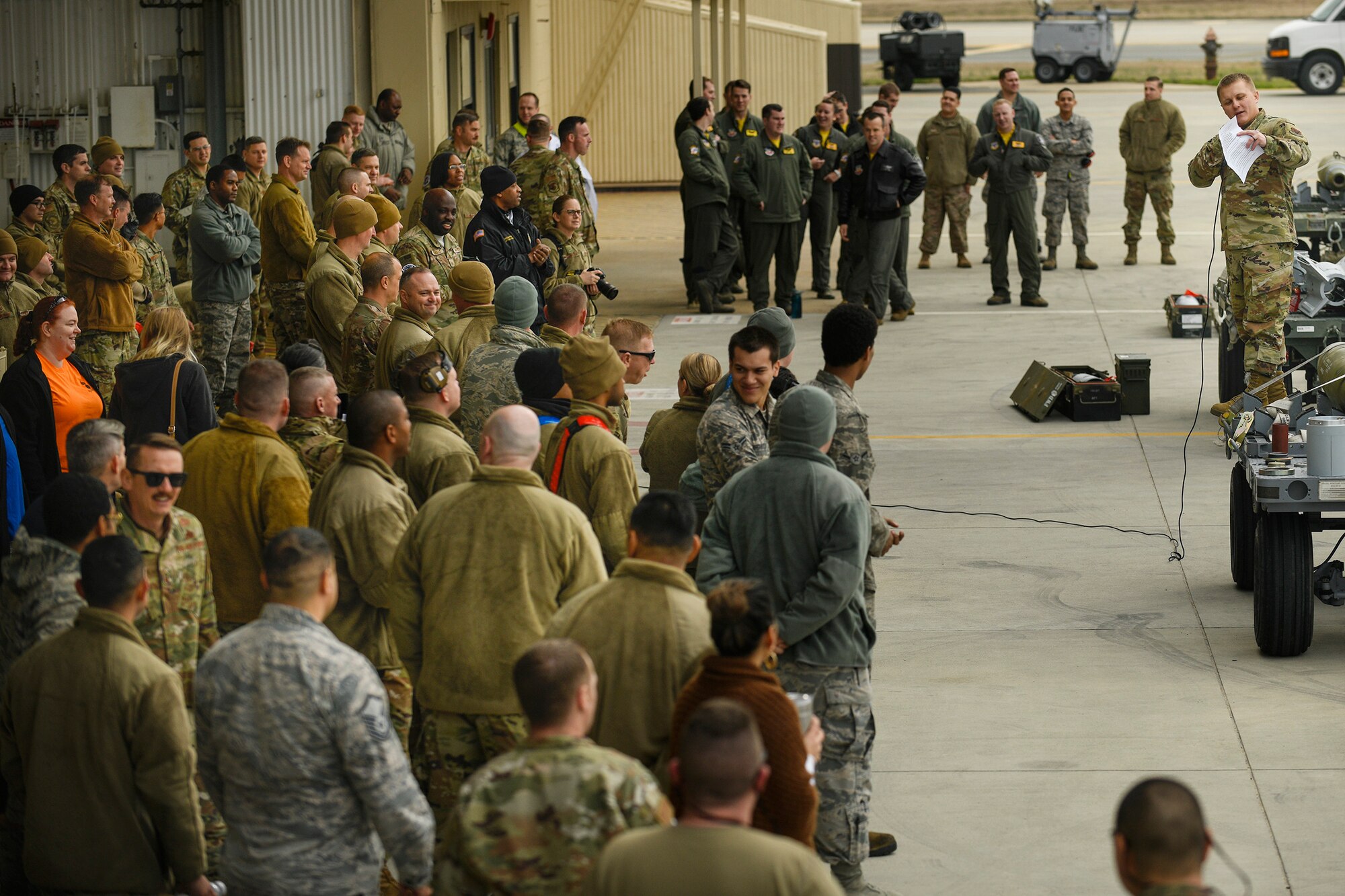 Tech. Sgt. Vasiliy Zorin, 4th Aircraft Maintenance Squadron, loading standardization crew, briefs a crowd of spectators and participants of the quarterly Load Crew Competition at Seymour Johnson Air Force Base, N.C., Jan. 24, 2020.