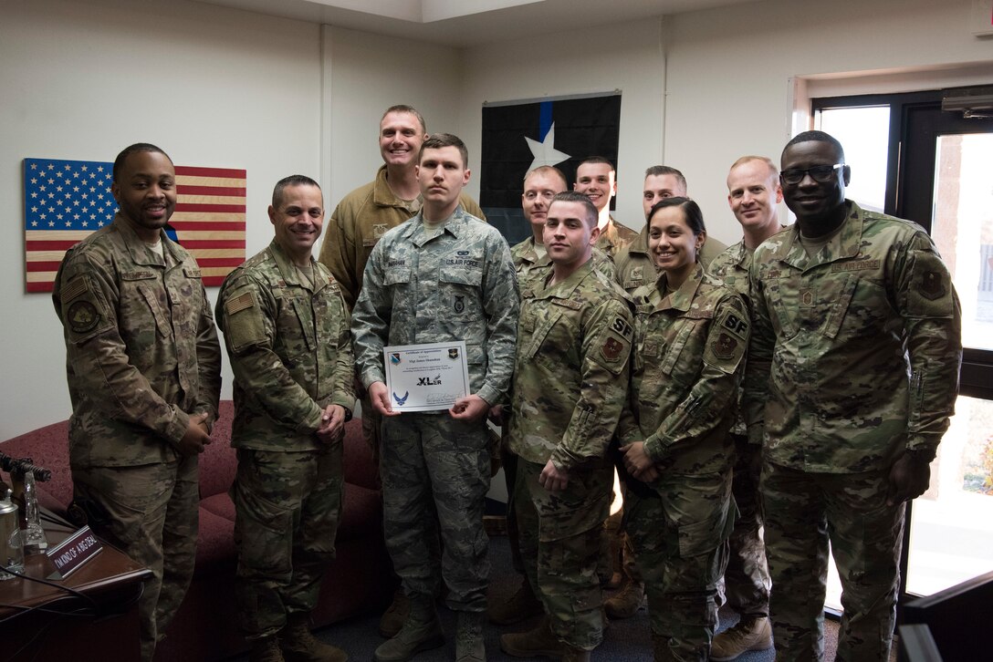 Staff Sgt. James Shanahan, 47th Security Forces Squadron trainer, accepts the “XLer of the week” award from Col. Lee Gentile, the 47th Flying Training Wing Commander, and Chief Master Sgt. Brian Lewis, 47th Operations Group superintendent, on Jan. 29, 2020 at Laughlin Air Force Base, Texas. The “XLer of the Week” award is given to those who consistently make outstanding contributions to their unit and the Laughlin mission. (U.S. Air Force photo by Senior Airman John A. Crawford)