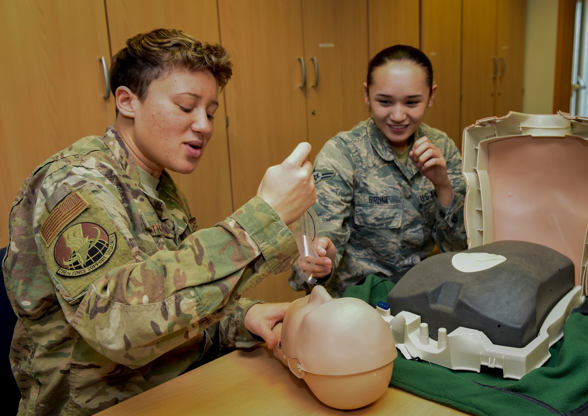U.S. Air Force Airman Olivia Carroll, left, 786th Force Support Squadron personnel specialist, and Airman 1st Class Bailey Brunk, 21st Operational Weather Squadron forecaster, assemble a cardiopulmonary resuscitation practice mannequin during an adult CPR and automated external defibrillator class at Ramstein Air Base, Germany, Feb. 4, 2020. The class is available three to four times weekly, and certifies students through the American Red Cross to perform CPR and abdominal thrusts. Certifications to perform life-saving techniques help keep Airmen ready to assist in emergencies.