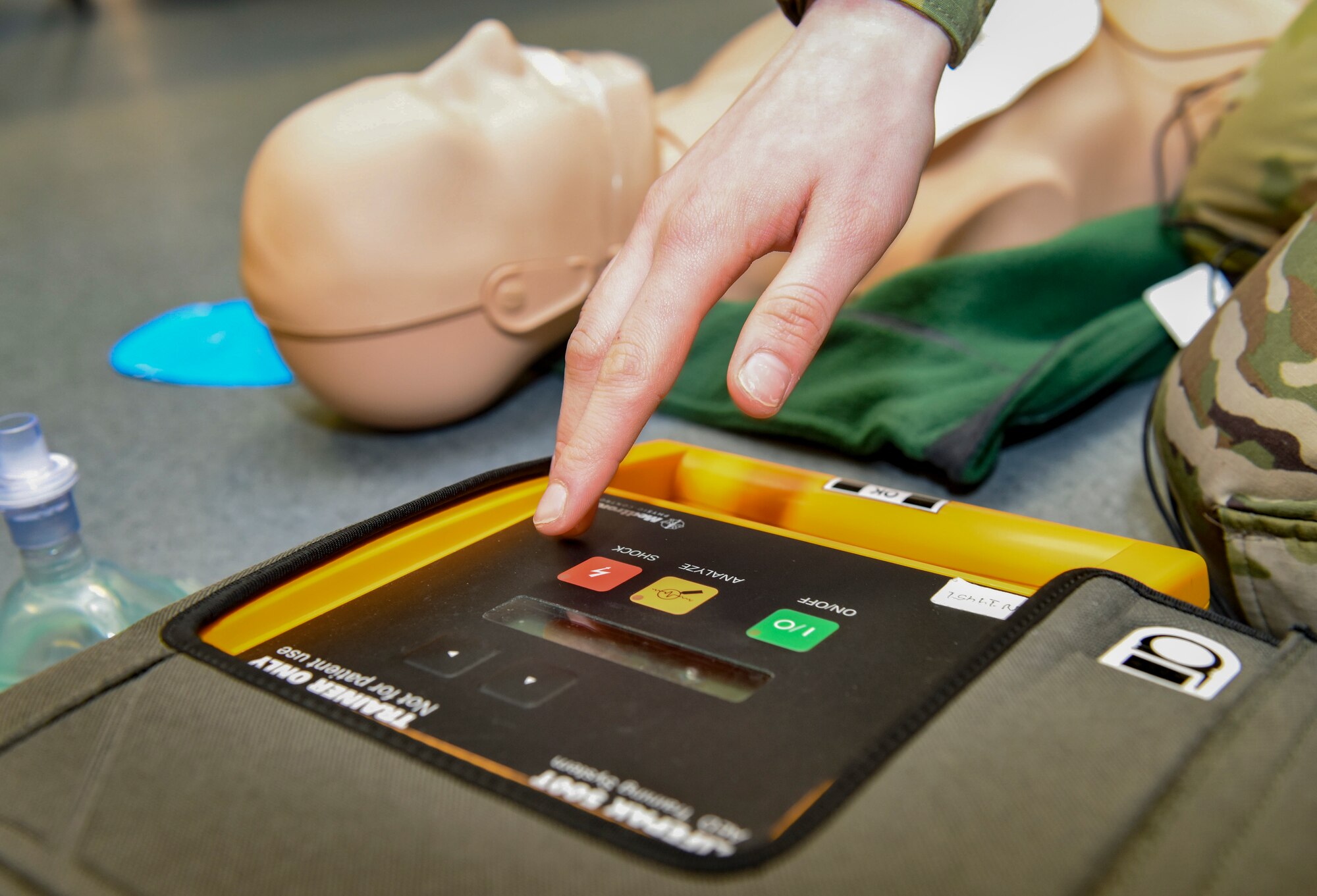 U.S. Air Force Airman 1st Class Jessica Paredes, 786th Force Support Squadron fitness center apprentice, prepares to administer a simulated automated external defibrillator shock to a mannequin during an adult cardiopulmonary resuscitation and AED class Ramstein Air Base, Germany, Feb. 4, 2020. Students learned how to use an AED to deliver electric shock to the heart. The shock can help restore normal heart rhythm to victims of cardiac arrest. Personnel who learn life-saving techniques help increase the safely of those around them both on and off the mission.