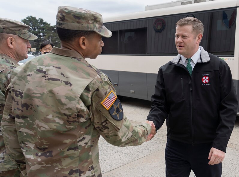 Col. Wheeler R. Manning, commander, 403rd Army Field Support Brigade, greets Secretary of the Army Ryan D. McCarthy as he arrives at Camp Carroll, South Korea, Jan. 29.