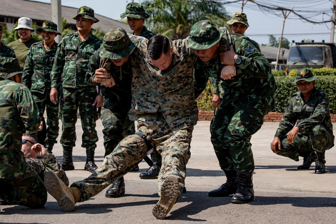 Service members with the Royal Thai Armed Forces carry a U.S. Marine during a supplemental landmine casualty care event on Banuransgri Camp in Ratchaburi Province, Kingdom of Thailand, Jan. 29.