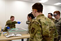 U.S. Air Force Staff Sgt. Sara Gould, a 372nd Training Squadron F-35A Lightning II Low Observable instructor, interacts with students at the field training detachment on Eielson Air Force Base, Alaska, Jan. 23, 2020.