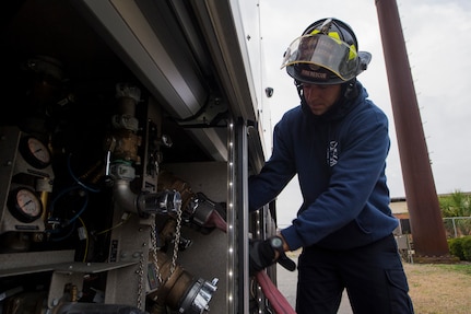 Matthew Callaghan, a firefighter assigned to the 628th Civil Engineer Squadron, attaches a hose to a firetruck to replenish its water supply at Joint Base Charleston, S.C., Feb. 6, 2020. The base fire department runs daily operations to maintain readiness in case of emergencies such as structure or aircraft fires, injury and other mishaps.