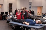 Red Cross personnel help an Employee at the Hart-Dole-Inouye Federal Center donate during the Feb. 5 blood drive.