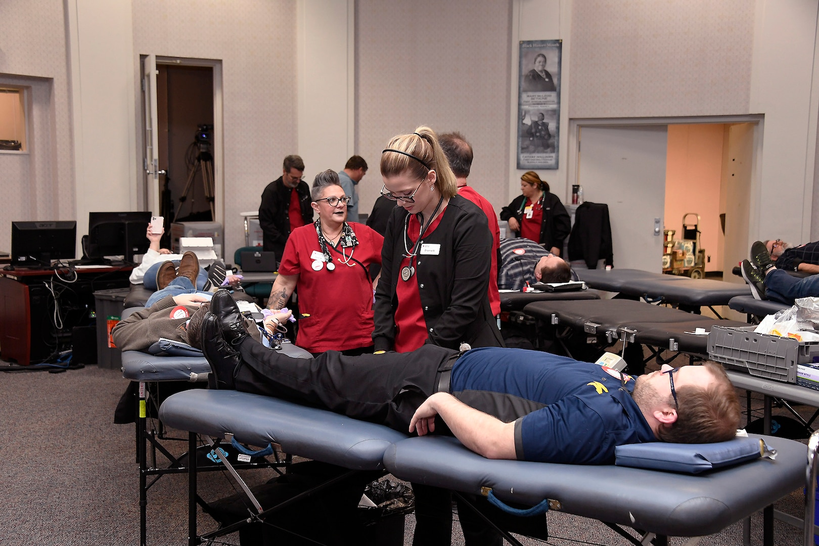 Red Cross personnel help an Employee at the Hart-Dole-Inouye Federal Center donate during the Feb. 5 blood drive.
