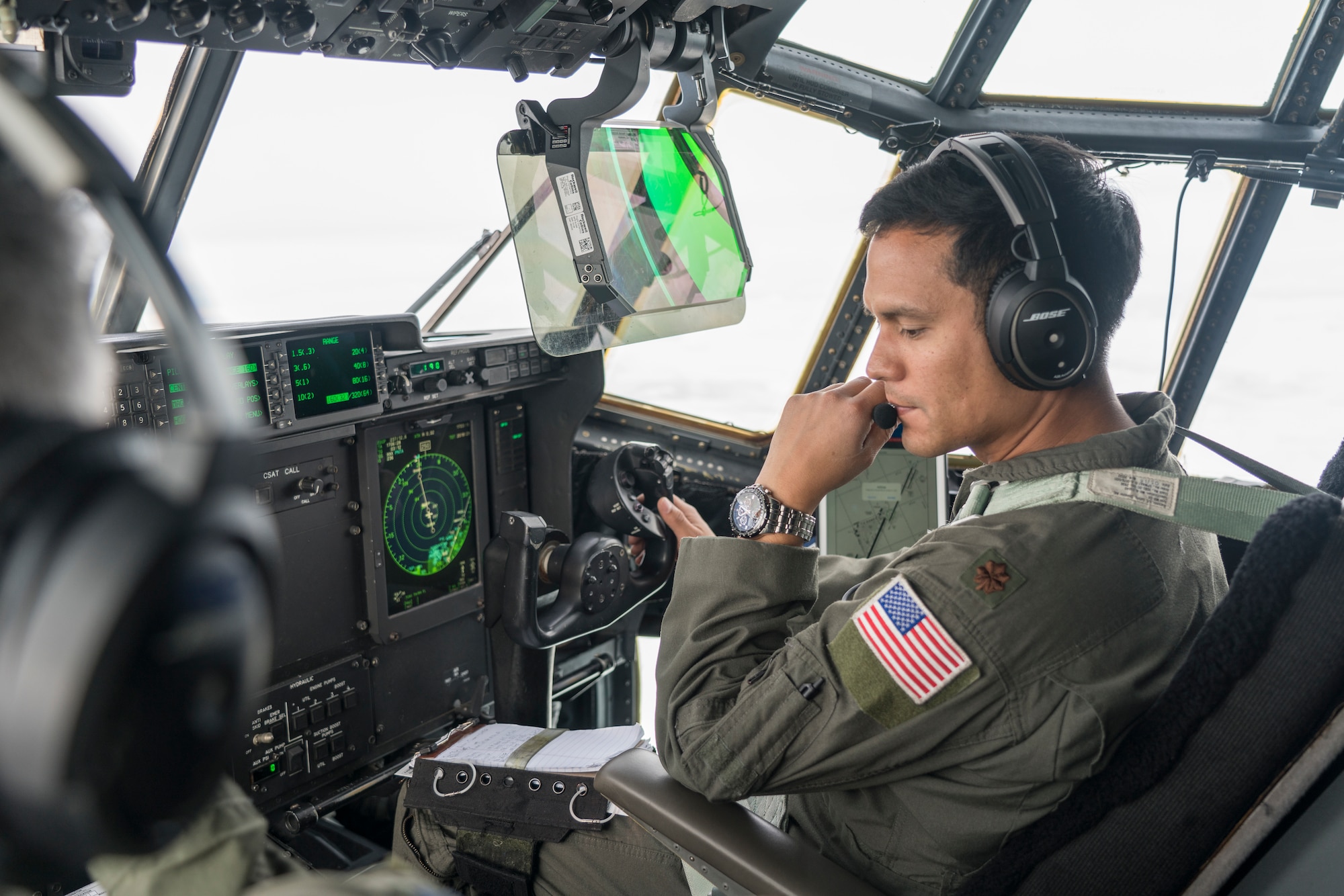 Maj. Jesse Rosal, 53rd Weather Reconnaissance Squadron pilot, talks over the radio communications system during an atmospheric river mission Jan. 28, over the Pacific Ocean. The Hurricane Hunters are slated to perform “AR recon” from January through March. Scientists led by Scripps Institution of Oceanography at University of California, San Diego, in partnership with the 53rd WRS, National Oceanic and Atmospheric Aviation’s National Weather Service and Office of Marine and Aviation Operations, will be on standby to fly through these ARs over the Pacific to gather data to improve forecasts. (U.S. Air Force photo by Tech. Sgt. Christopher Carranza)