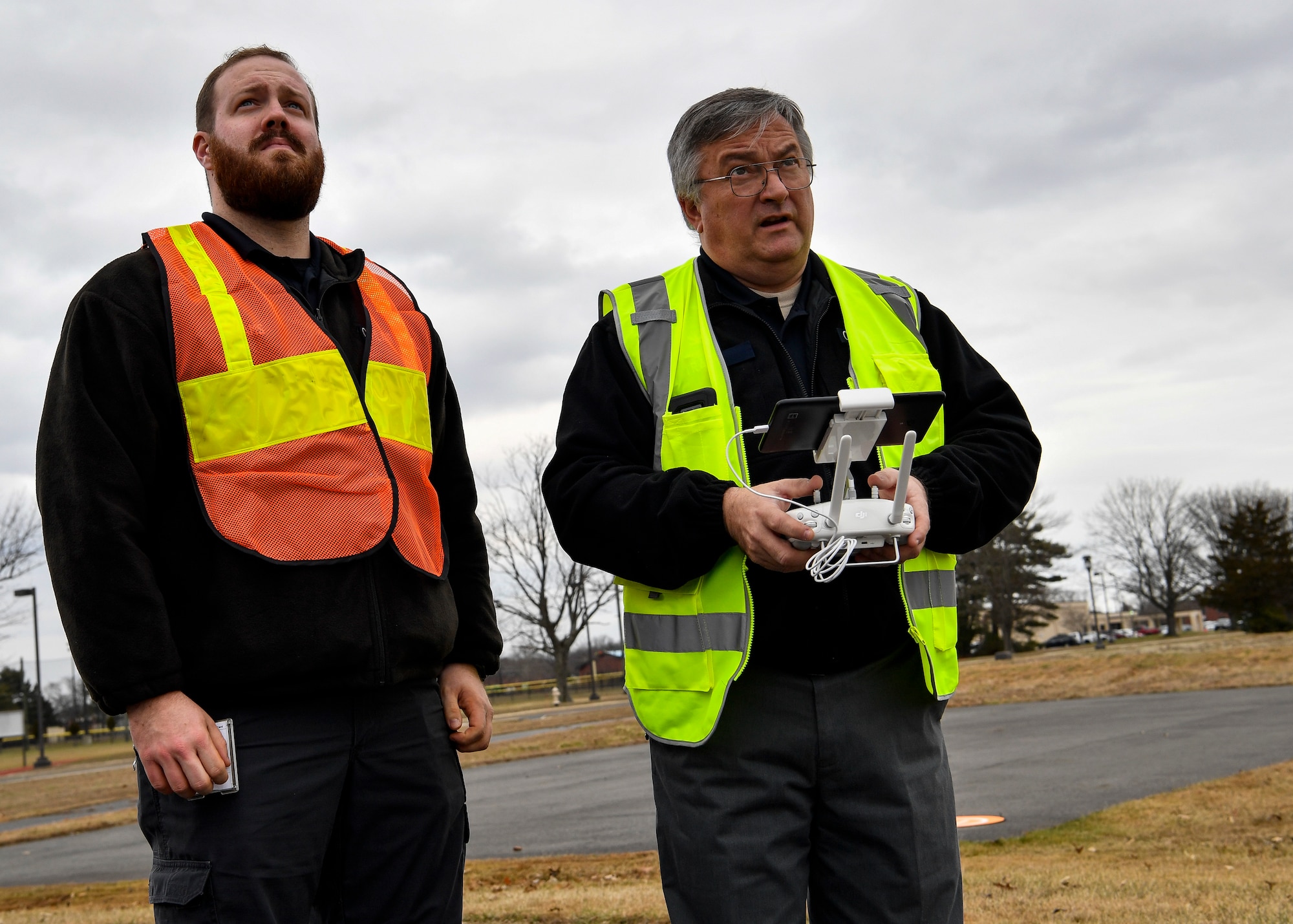 Photo of two individuals operating a drone.