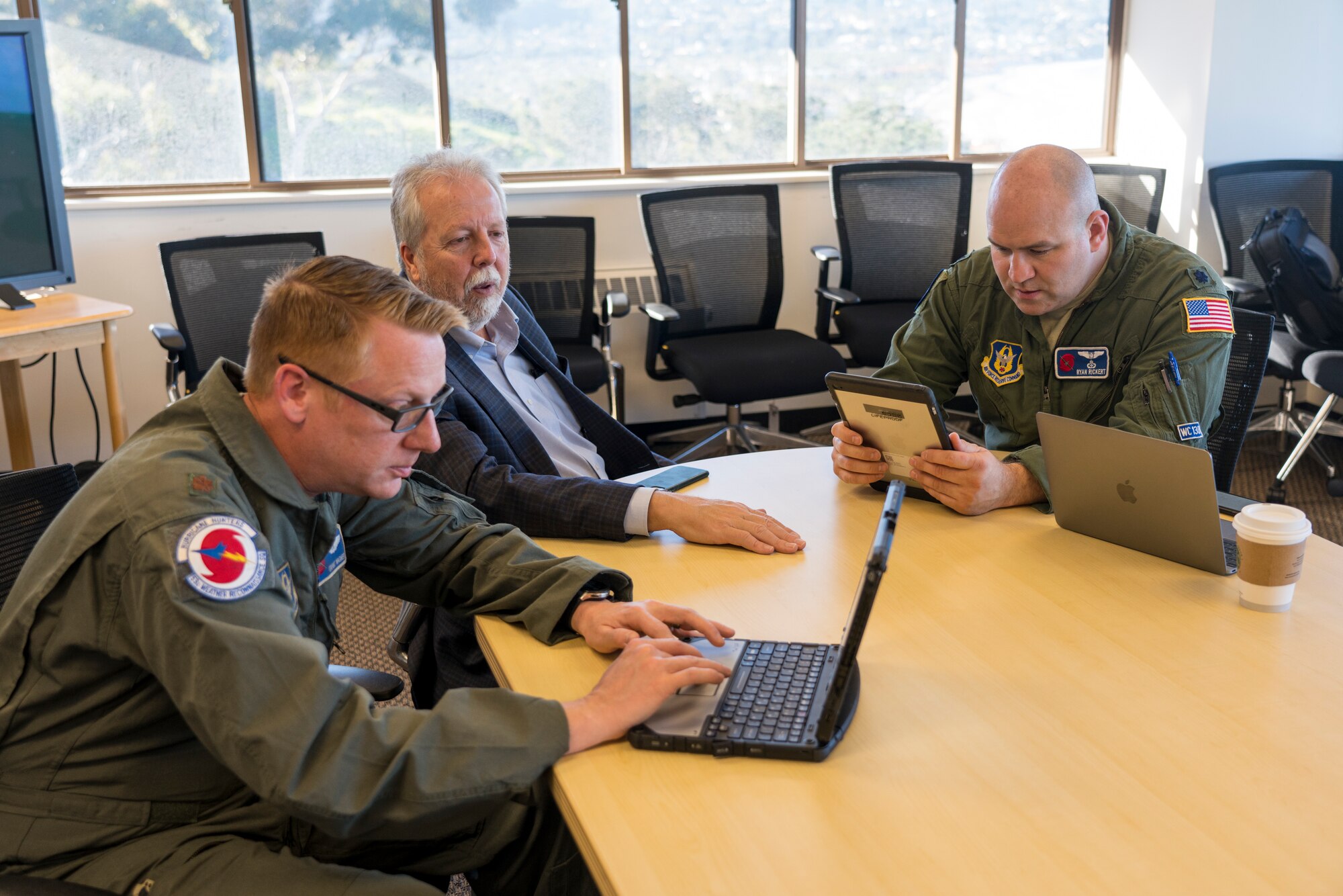From left to right: Maj. Grant Wagner, 53rd Weather Reconnaissance Squadron navigator,  F. Martin Ralph, principal investigator for the Atmospheric River Recon program and director of the Center for Western Weather and Water Extremes and Lt Col. Ryan Rickert, 53rd WRS aerial weather reconnaissance officer, work on a flight plan for the next atmospheric river mission Jan. 30 at San Diego, Calif. The Hurricane Hunters are slated to perform “AR recon” from January through March. Scientists led by Scripps at University of California, in partnership with the 53rd WRS, National Oceanic and Atmospheric Aviation’s National Weather Service, NOAA’s Office of Marine and Aviation Operations, will be on standby to fly through these ARs over the Pacific to gather data to improve forecasts. (U.S. Air Force photo by Tech. Sgt. Christopher Carranza)