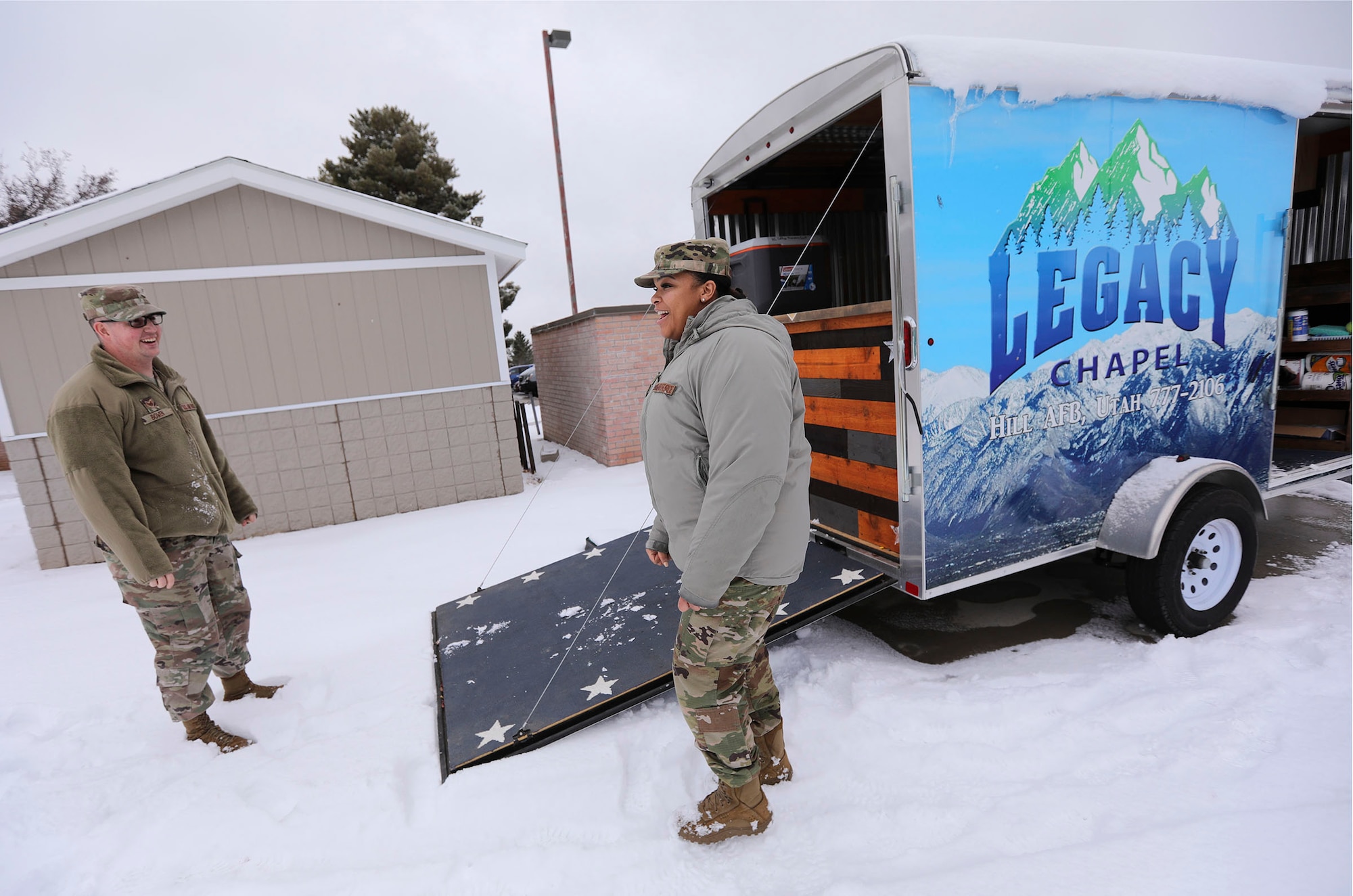 Staff Sgt. Garrett Bowen and Senior Airman Shakira Laws-Mathis, religious affairs, show a ministry cart they use for outreach, offering coffee and hot beverages around Hill Air Force Base.