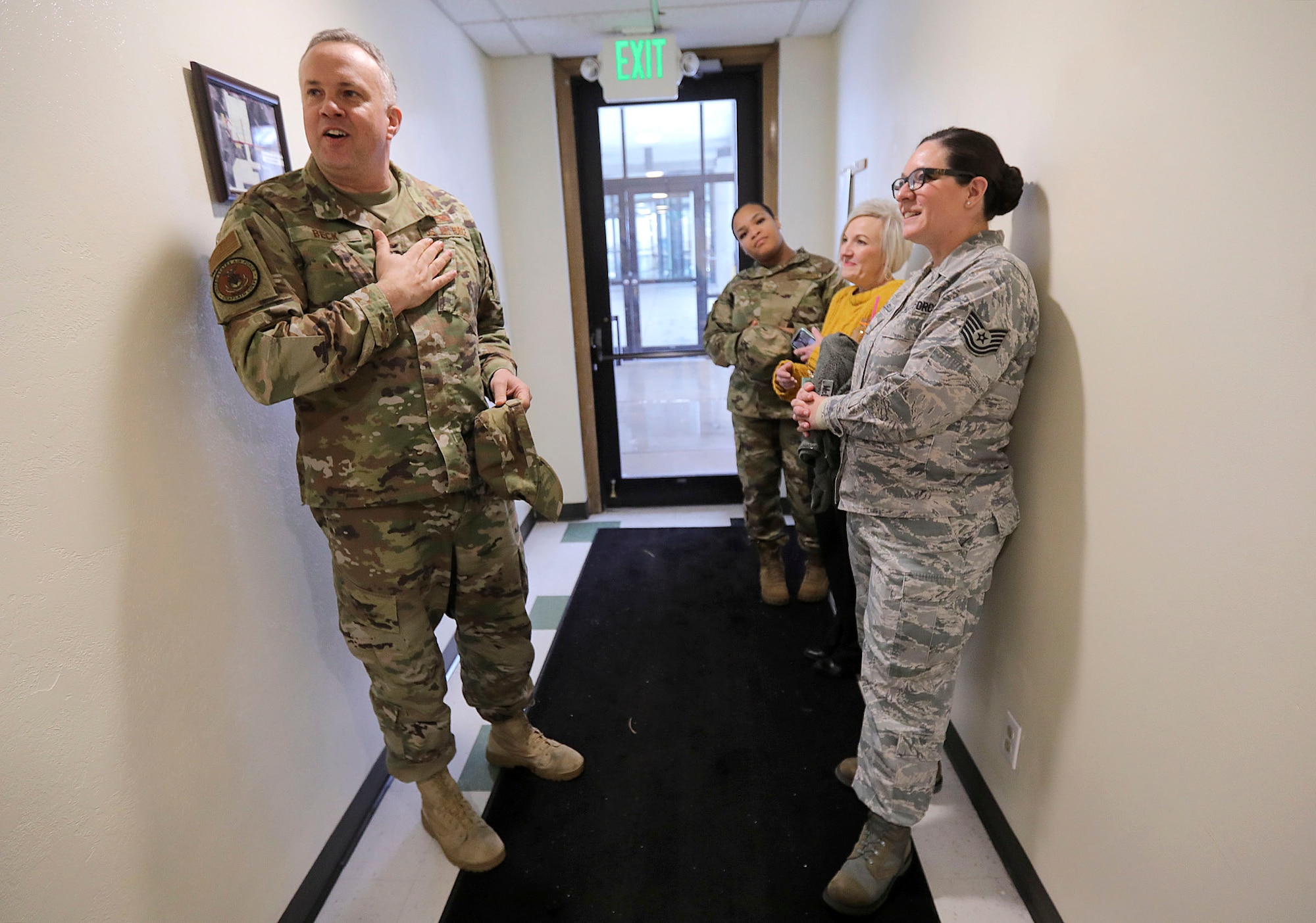 Lt. Col. Zebulon Beck, Hill Air Force Base wing chaplain, left, talks about football rivalries with Senior Airman Shakira Laws-Mathis, religious affairs, center, Charity Balce, chapel tithes and offerings fund account manager, and Tech Sgt. Crystal McClellan, non-commissioned officer in charge of religious affairs, at the base chapel.