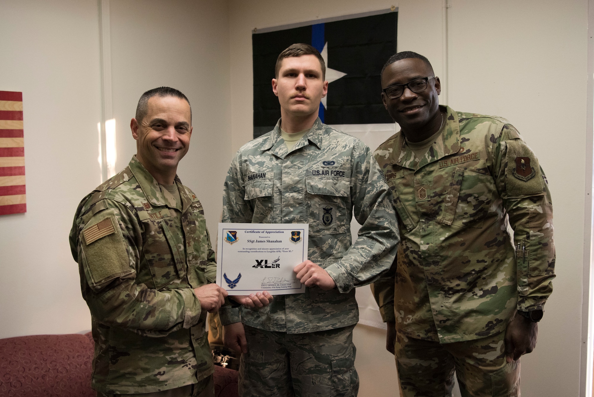 Staff Sgt. James Shanahan, 47th Security Forces Squadron trainer, accepts the “XLer of the week” award from Col. Lee Gentile, the 47th Flying Training Wing Commander, and Chief Master Sgt. Brian Lewis, 47th Operations Group superintendent, on Jan. 29, 2020 at Laughlin Air Force Base, Texas. The “XLer of the Week” award is given to those who consistently make outstanding contributions to their unit and the Laughlin mission. (U.S. Air Force photo by Senior Airman John A. Crawford)
