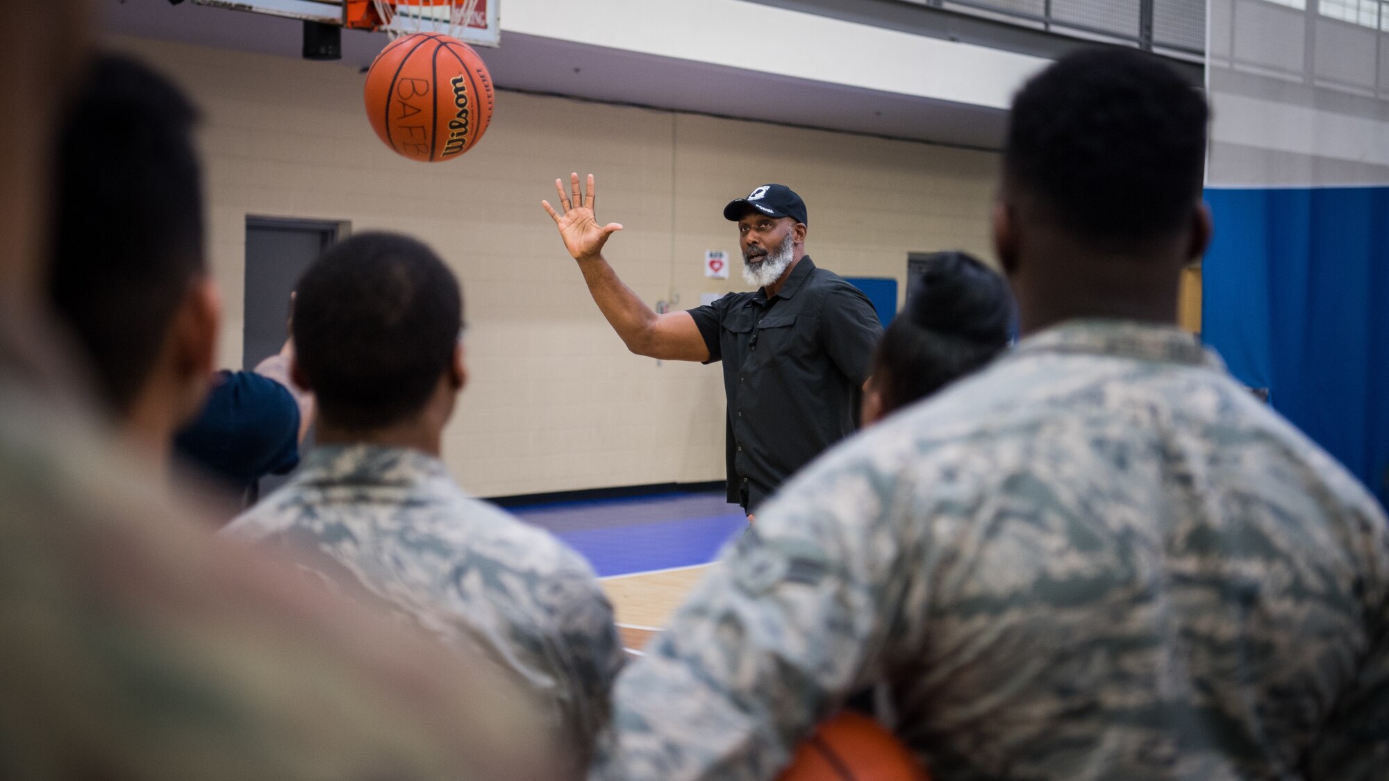 Karl Malone, NBA Hall of Famer, visits with Airmen at the Senior Airman Bell Fitness Center at Barksdale Air Force Base, La., Feb. 4, 2020. Malone spent time talking to Airmen talking about leadership and even giving a few tips to the base intramural basketball team. (U.S. Air Force photo by Airman 1st Class Jacob B. Wrightsman)