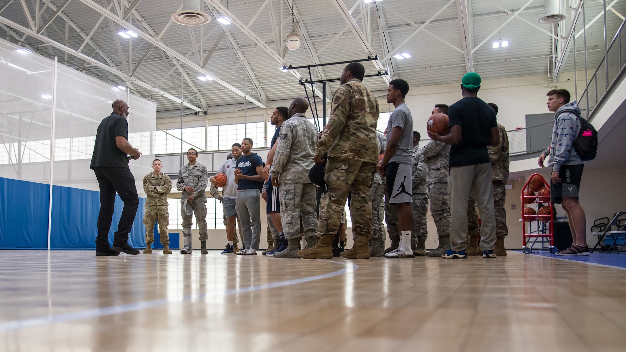 Karl Malone, NBA Hall of Famer, talks with Airmen at the Senior Airman Bell Fitness Center at Barksdale Air Force Base, La., Feb. 4, 2020. Malone spent time talking to Airmen talking about leadership and even giving a few tips to the base intramural basketball team. (U.S. Air Force photo by Airman 1st Class Jacob B. Wrightsman)