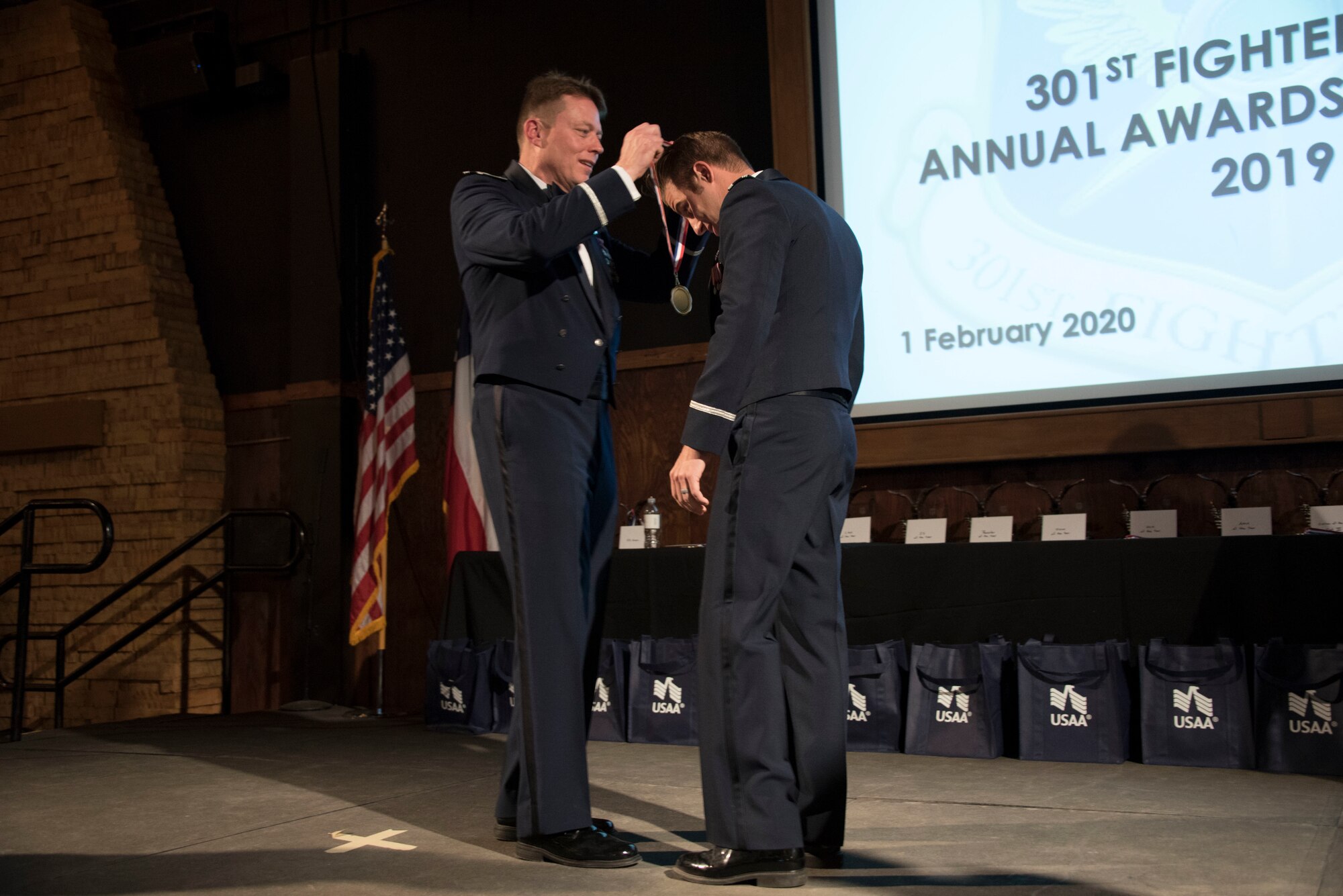 Colonel Mitch Hanson, 301st Fighter Wing commander places a medallion around the neck of Capt. Brett Gedman 44th Fighter Group Company Grade Officer of the Year nominee at the 301 FW Annual Awards Ceremony held on February 1 at River Ranch, Fort Worth, Texas. Throughout the 12 award categories, 48 nominees were selected throughout the wing. (U.S. photo by Capt. Jessica Gross)