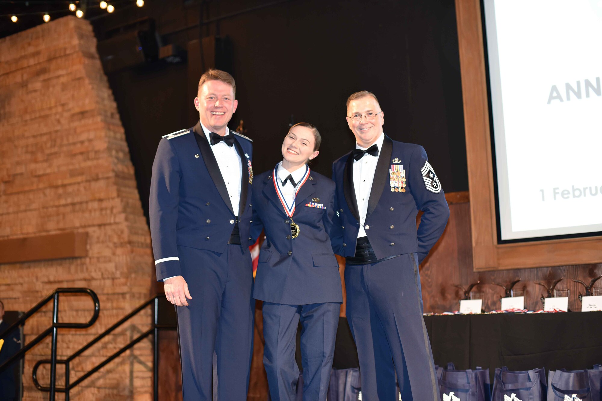 Colonel Mitch Hanson, 301st Fighter Wing commander and Chief Master Sgt. Rob Safley, 301st command chief take a picture with Senior Airman Sarah Veness 301 FW Operations Group 2019 Airman of the year nominee at the 301 FW Annual Awards Ceremony held on February 1 at River Ranch, Fort Worth, Texas. Medallions given to the nominees symbolize the recognition of their hard work and superior performance. (U.S. photo by Capt. Jessica Gross)