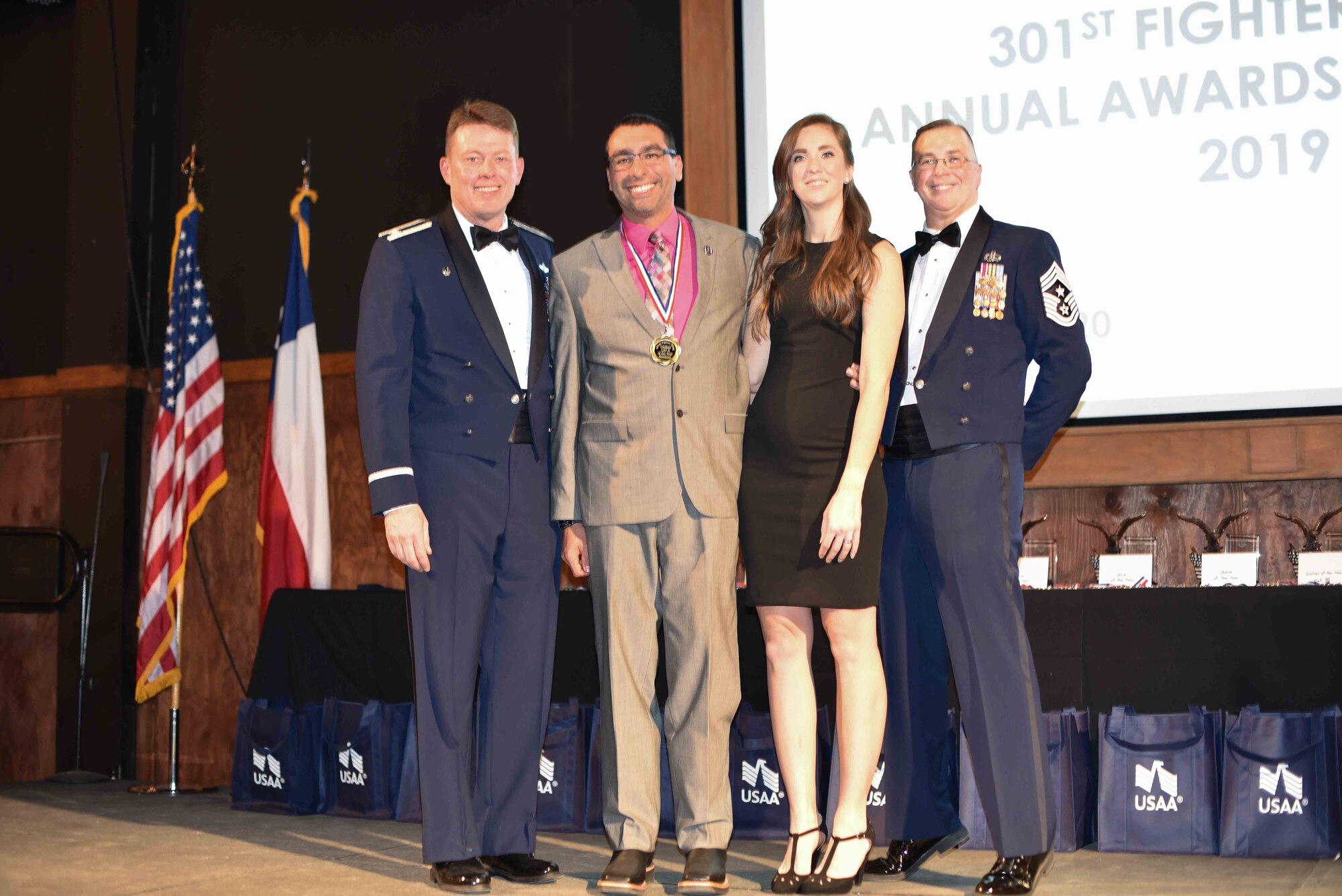 Colonel Mitch Hanson, 301st Fighter Wing commander and Chief Master Sgt. Rob Safley, 301st command chief take a picture with Mr. Scott Palomino and his wife at the 301 FW Annual Awards Ceremony held on February 1 at River Ranch, Fort Worth, Texas. Mr. Palomino would go on to be selected as the 	Civilian of the Year: Category II from the 301 FW Force Support Squadron. (U.S. photo by Capt. Jessica Gross)