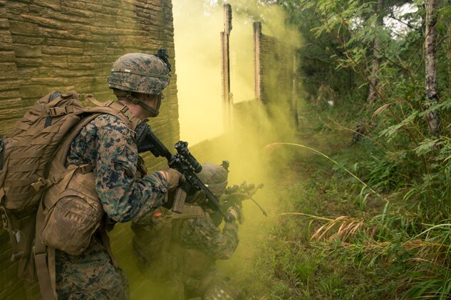 Marines with Alpha Company, Battalion Landing Team, 1st Battalion, 5th Marines, 31st Marine Expeditionary Unit, close with an enemy machine gun position during a simulated raid at the Central Training Area, Okinawa, Japan, on Dec. 11, 2019. The 31st MEU is currently preparing for deployment through MEUEX, a two-week evolution that prepares the Marine Air-Ground Task Force for amphibious operations launched from naval vessels. The 31st MEU, the Marine Corps' only continuously forward-deployed MEU, provides a flexible and lethal force ready to perform a wide range of military operations as the premier crisis response force in the Indo-Pacific region. (Official U.S. Marine Corps photo by Lance Cpl. Andrew R. Bray)