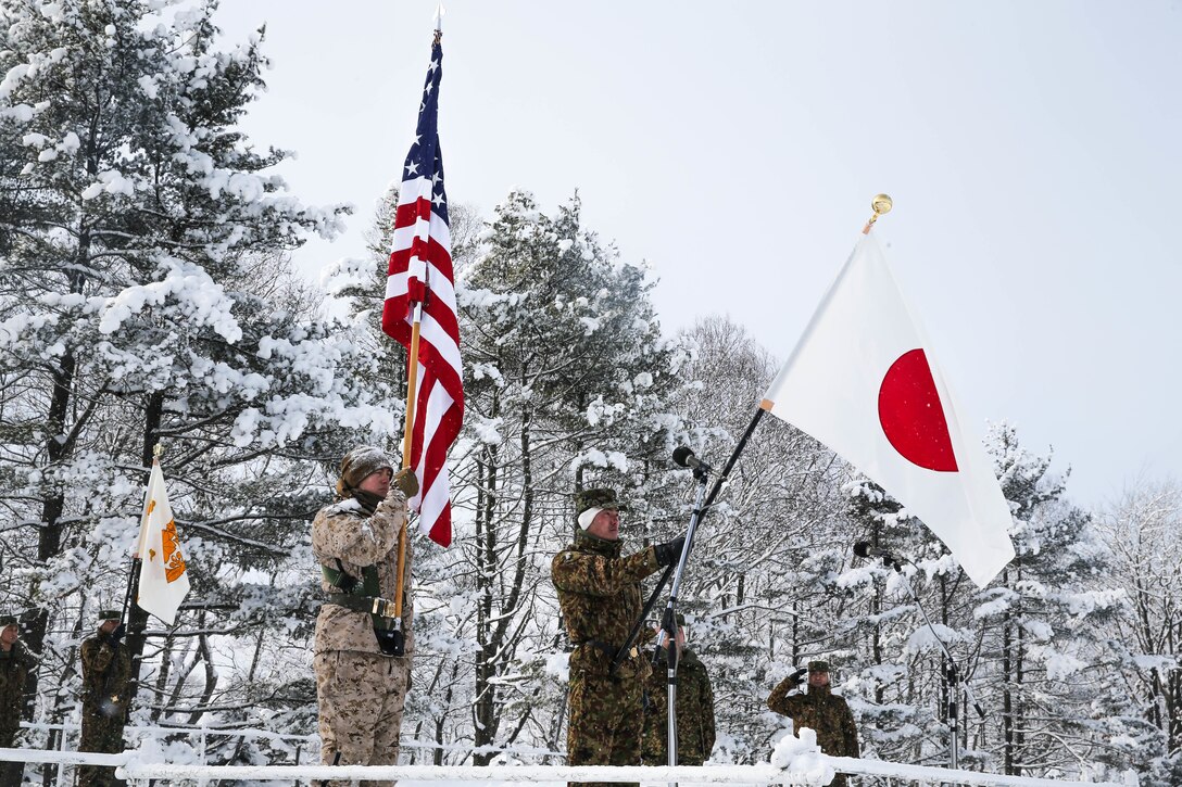 U.S. Marines and Soldiers from Japan Ground Self-Defense Force (JGSDF) watch as flags are presented during an opening ceremony for exercise Northern Viper on Hokudaien Training Area, Hokkaido, Japan, Jan. 26, 2020. Northern Viper is a regularly scheduled training exercise that is designed to enhance the interoperability of the U.S. and Japan Alliance by allowing infantry units to maintain their lethality and proficiency in infantry and combined arms tactics. (U.S. Marine Corps Photo By Cpl. Cameron E. Parks)